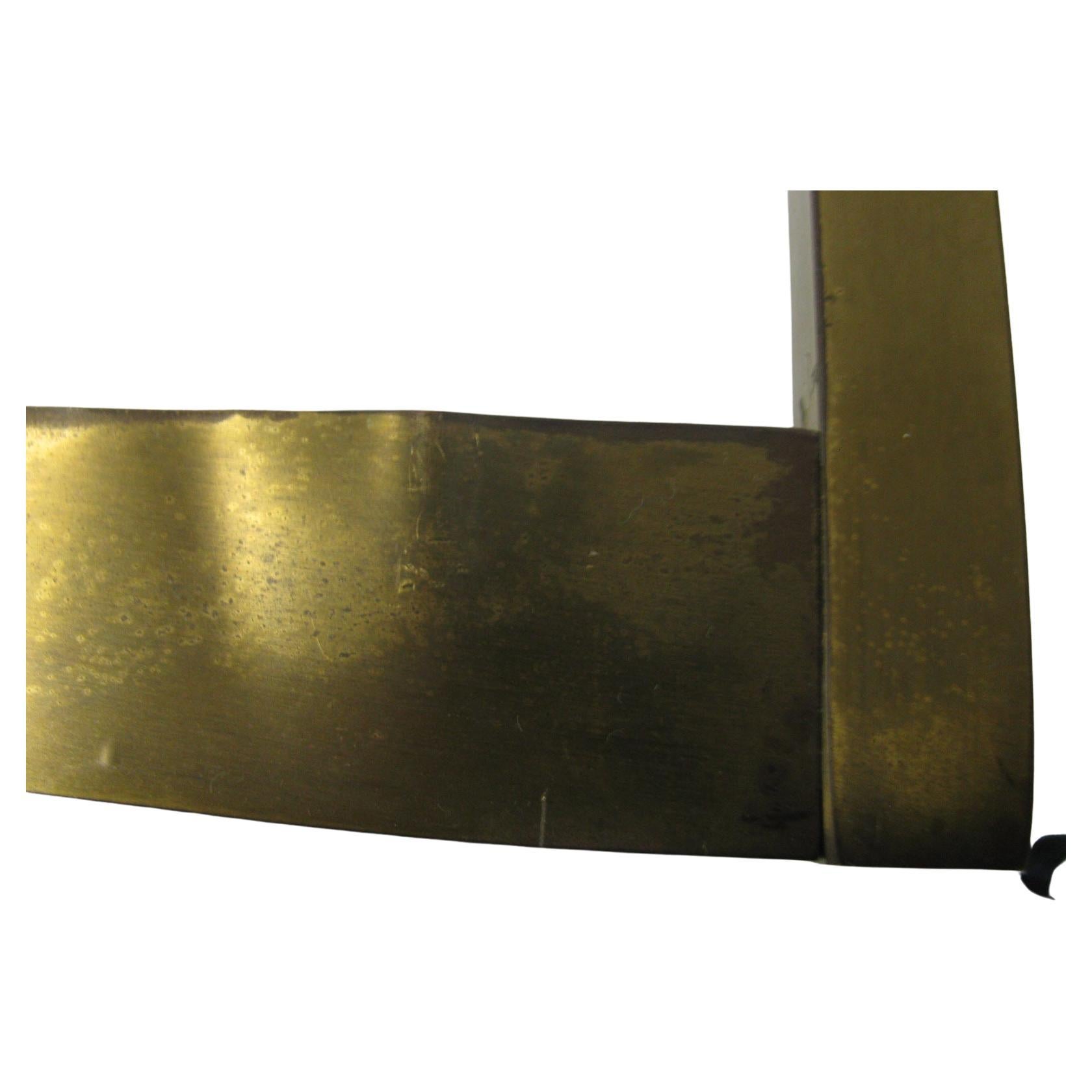 Simple and elegant square brass cocktail table by Harvey Probber. X stretcher giving an architectural element to the piece and providing strength to the frame. In very good vintage condition with a tiny blemish to the brass (pictured). Original