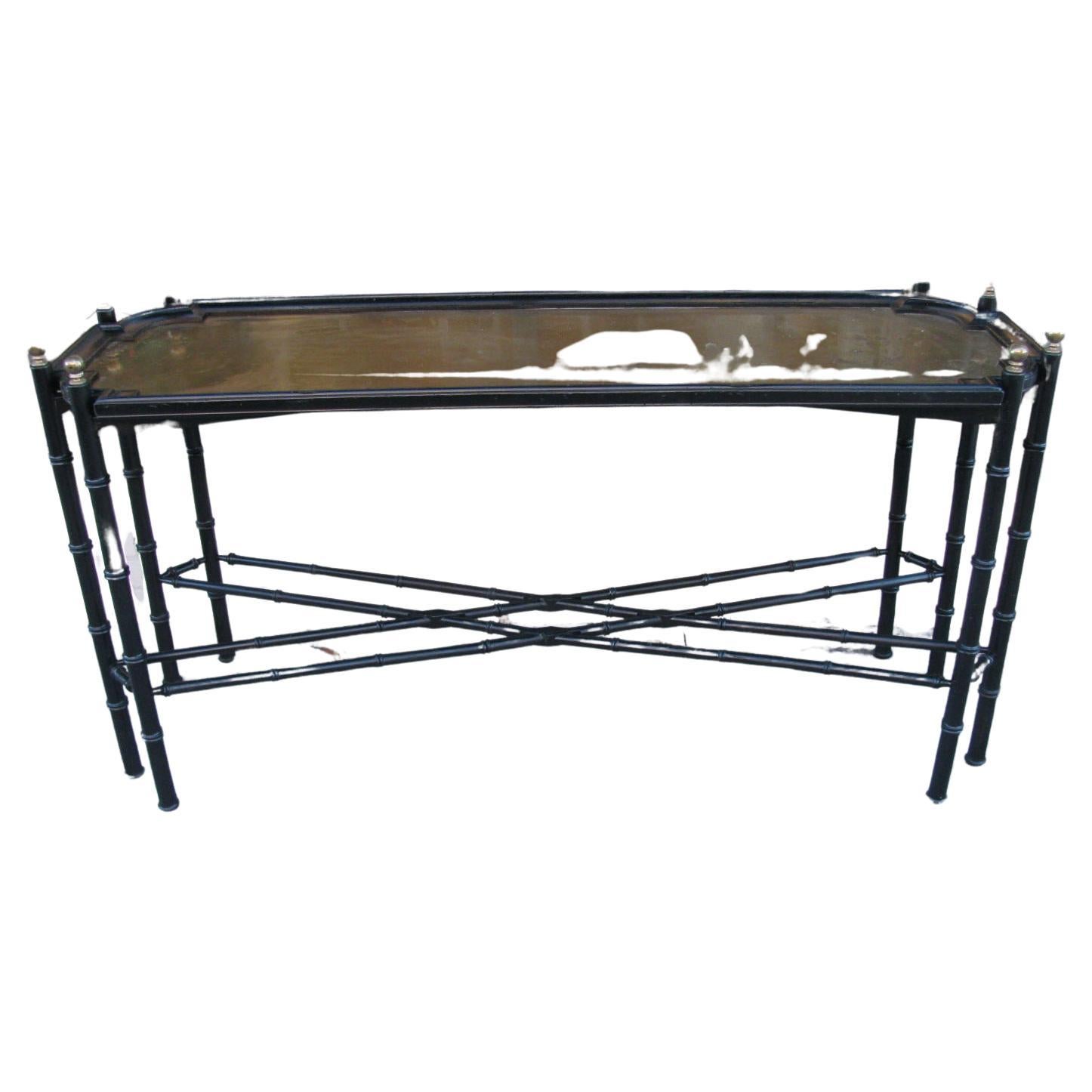 Fabulous 8 leg faux bamboo sofa table with a brass tray top. Black enamel with brass caps atop each leg. Stretchers cross on both bottom and top sections creating X-stretchers. Would work well in numerous settings. Tray is tarnished, can be polished