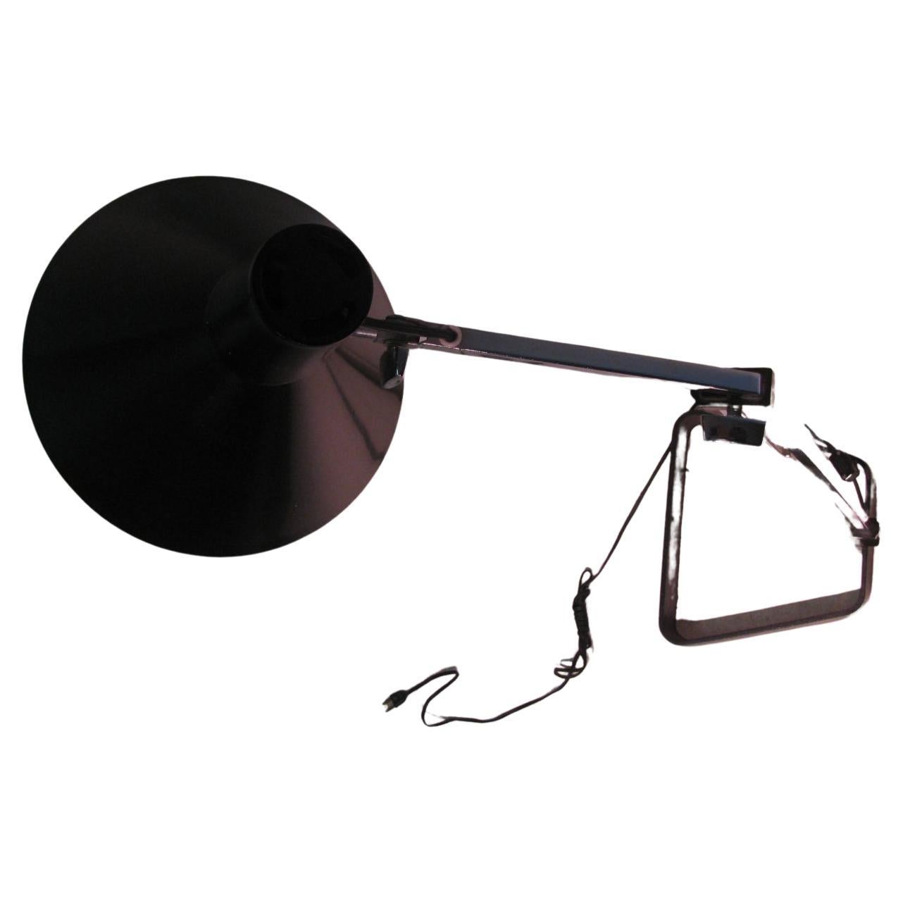 Elegant and simple design. Adjustable floor lamp created out of square chromed steel which rises to 57.5 and will lower to 39in. Black flared shade also is adjustable. Heavy steel base with a unique open design. Wiring is sound, takes a regular