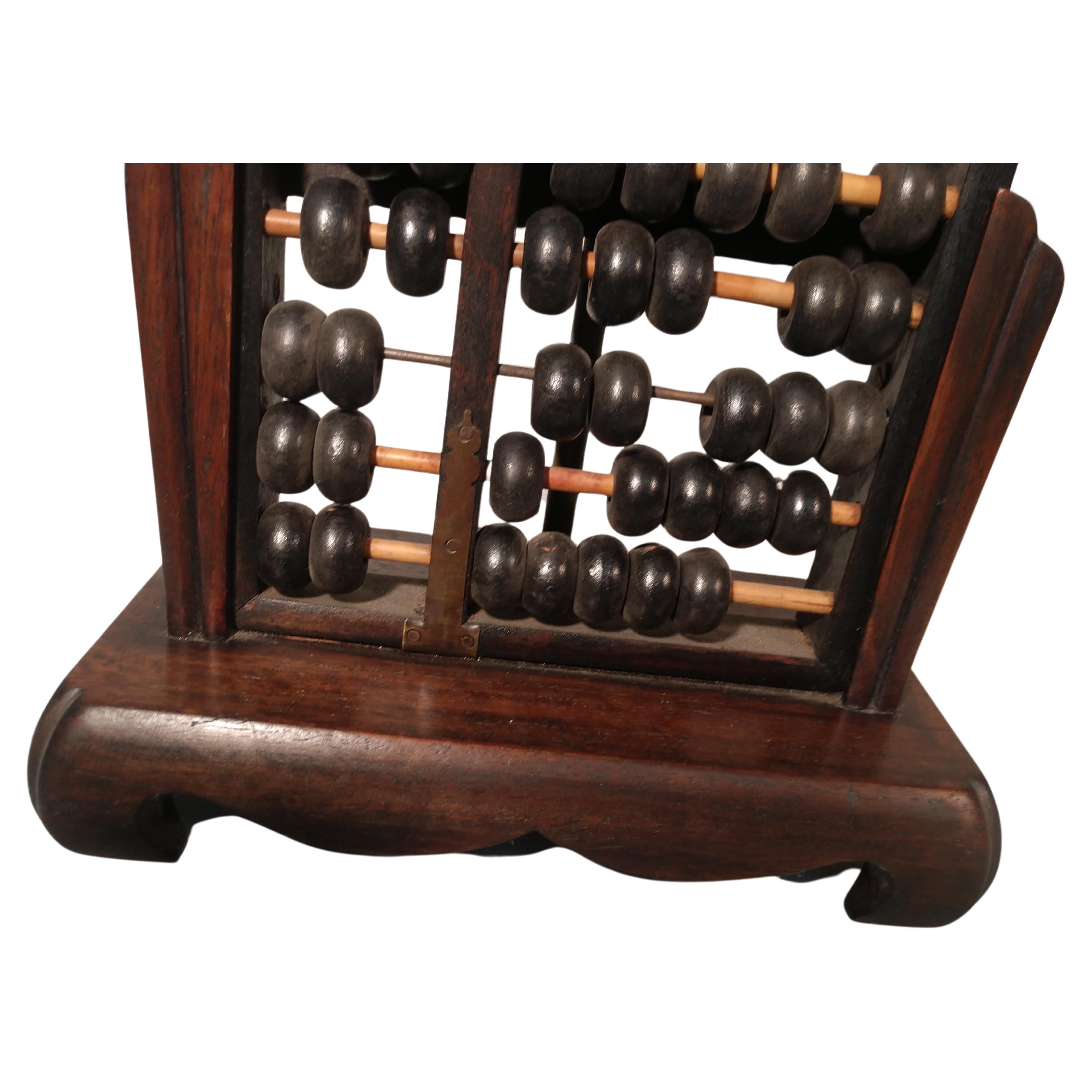 Chinese abacus table lamp in hardwood with an ebonized counting frame and brass accents. Used for centuries in the Near East. This particular lamp is from the early 1960s and in great condition. Lamp shade included.