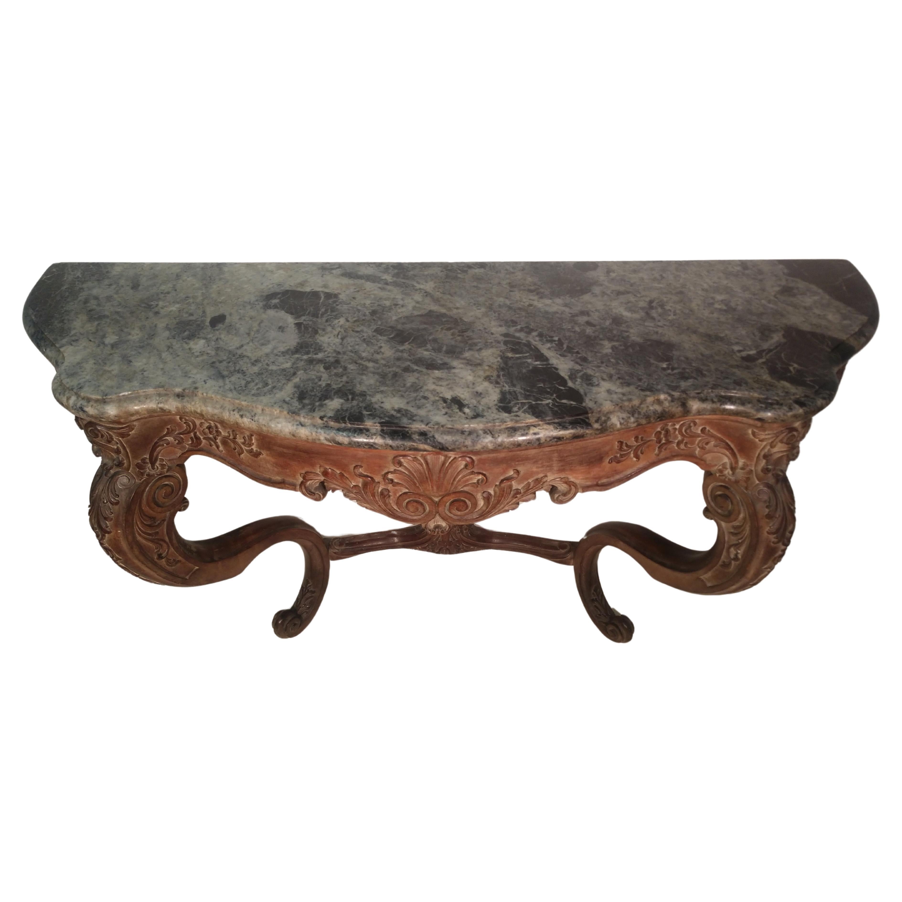Fabulous carved serpentine console base dark green heavily veined marble. In the Rococo style with fabulous carvings on the legs and apron. Stamped Jansen in the walnut apron inside edge. Great for a dining area because of its size, 5 ft. Also as a