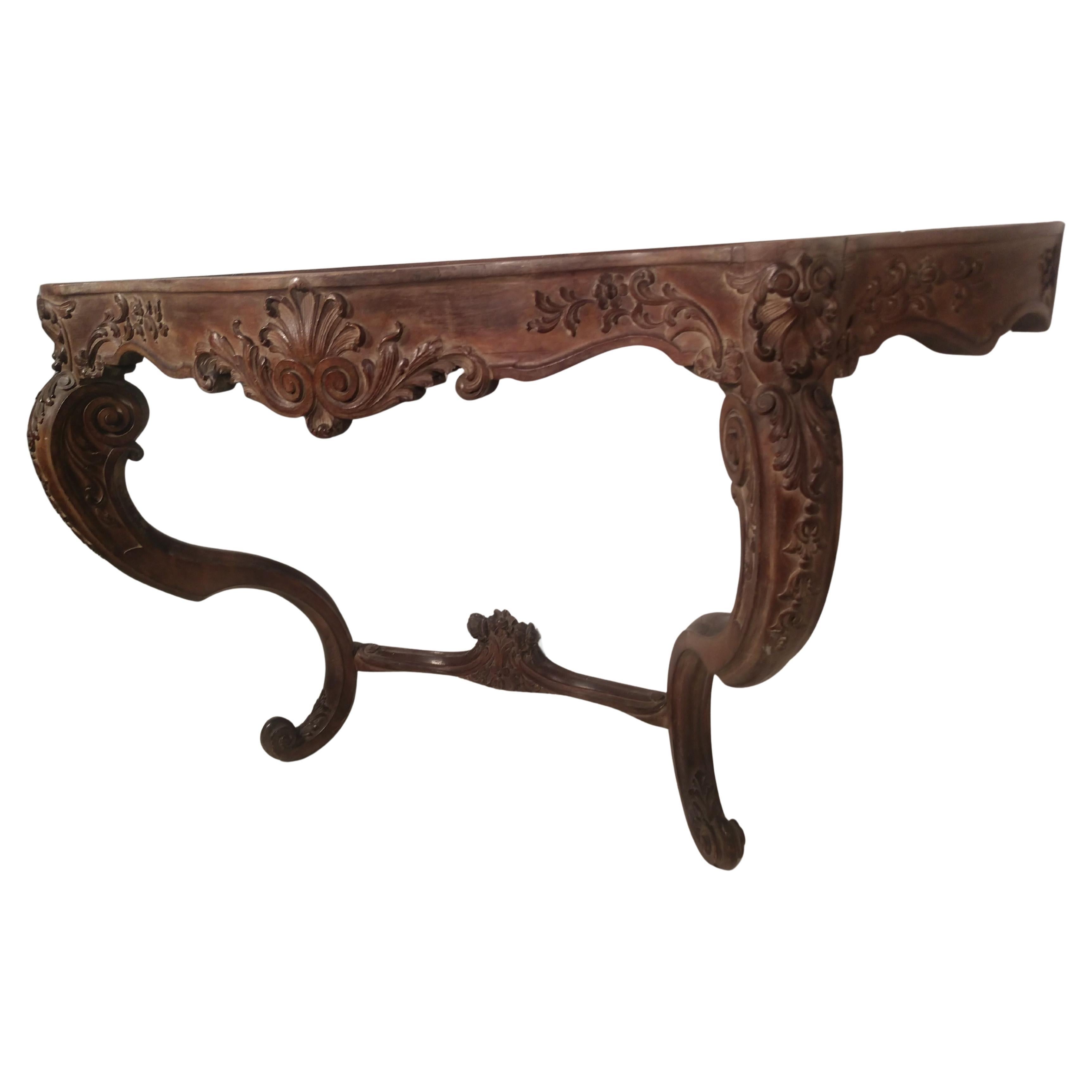 Fabulous carved serpentine console base dark green heavily veined marble. In the Rococo style with fabulous carvings on the legs and apron. Stamped Jansen in the walnut apron inside edge. Great for a dining area because of its size, 5 ft. Also as a