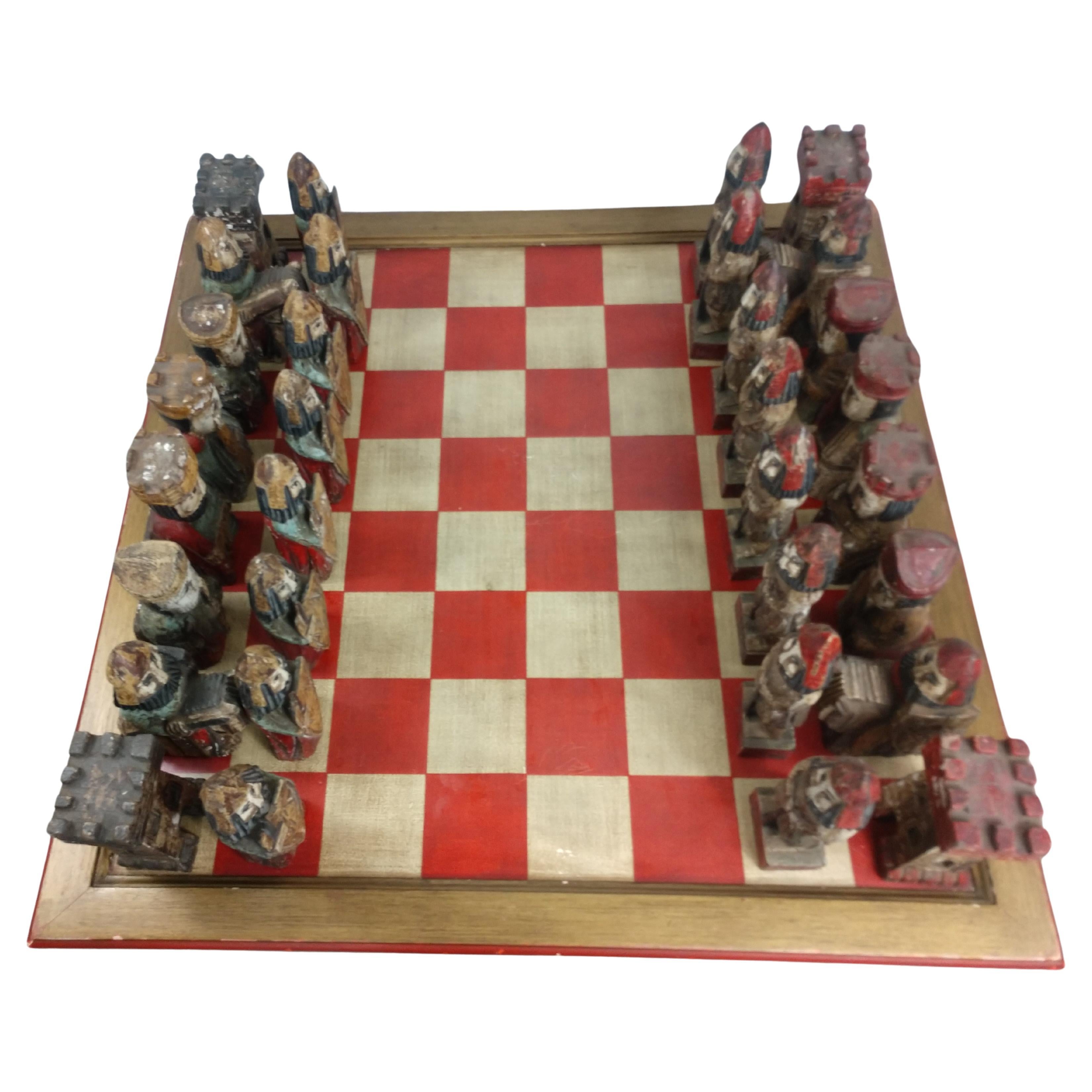 Fabulous game cocktail chess table from the mid sixties. Hand carved and polychrome figures which are easily stored below the chess table top. Great color and fantastic brutalist style wood carvings. Figures are from 10 x 2 x 2 to 9 x 6 x 2 in size.