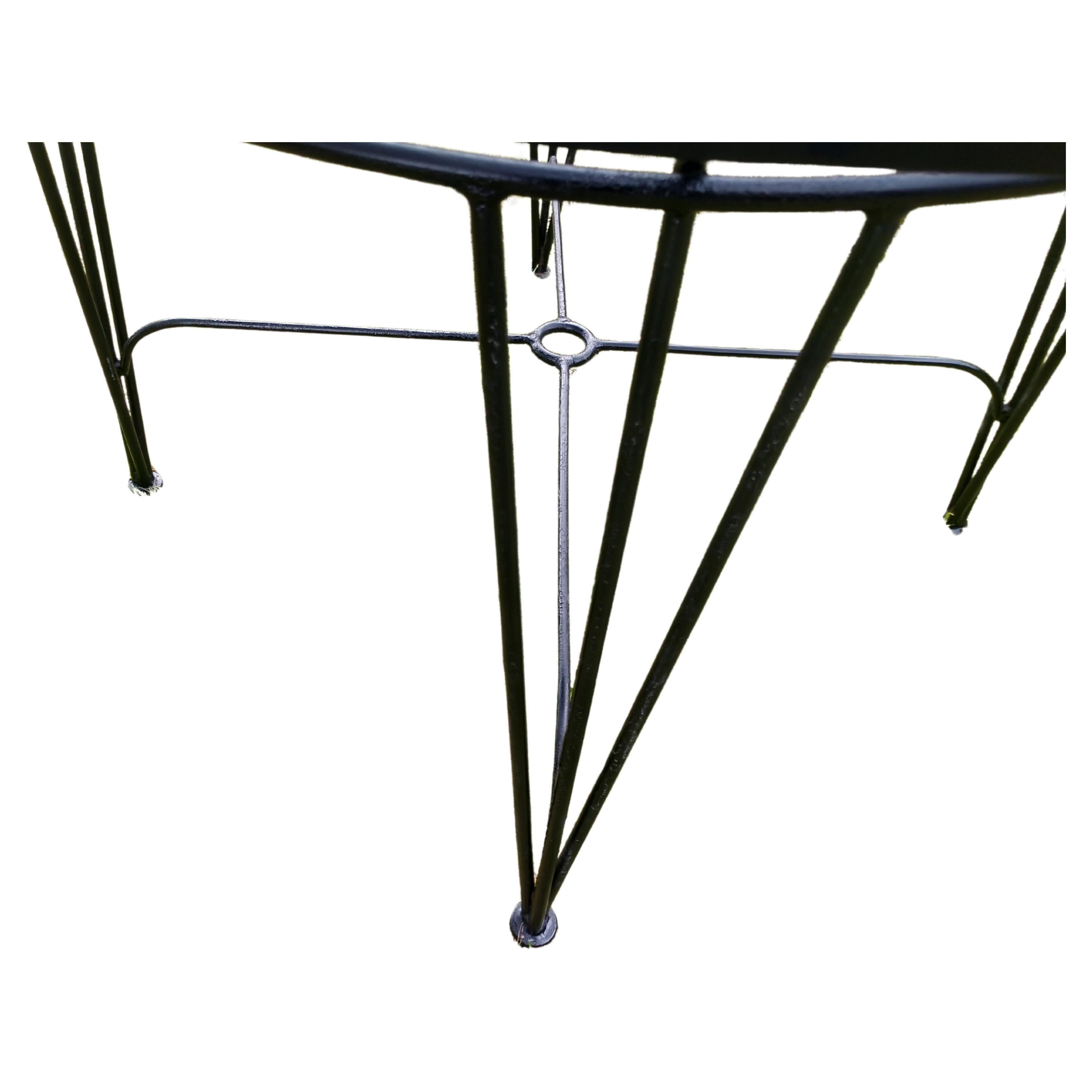 Fabulous patio dining table with mesh top outfitted with a fitting for an umbrella. Hand made in the fifties with galvanized iron. Recently enameled in satin black. Very sturdy.