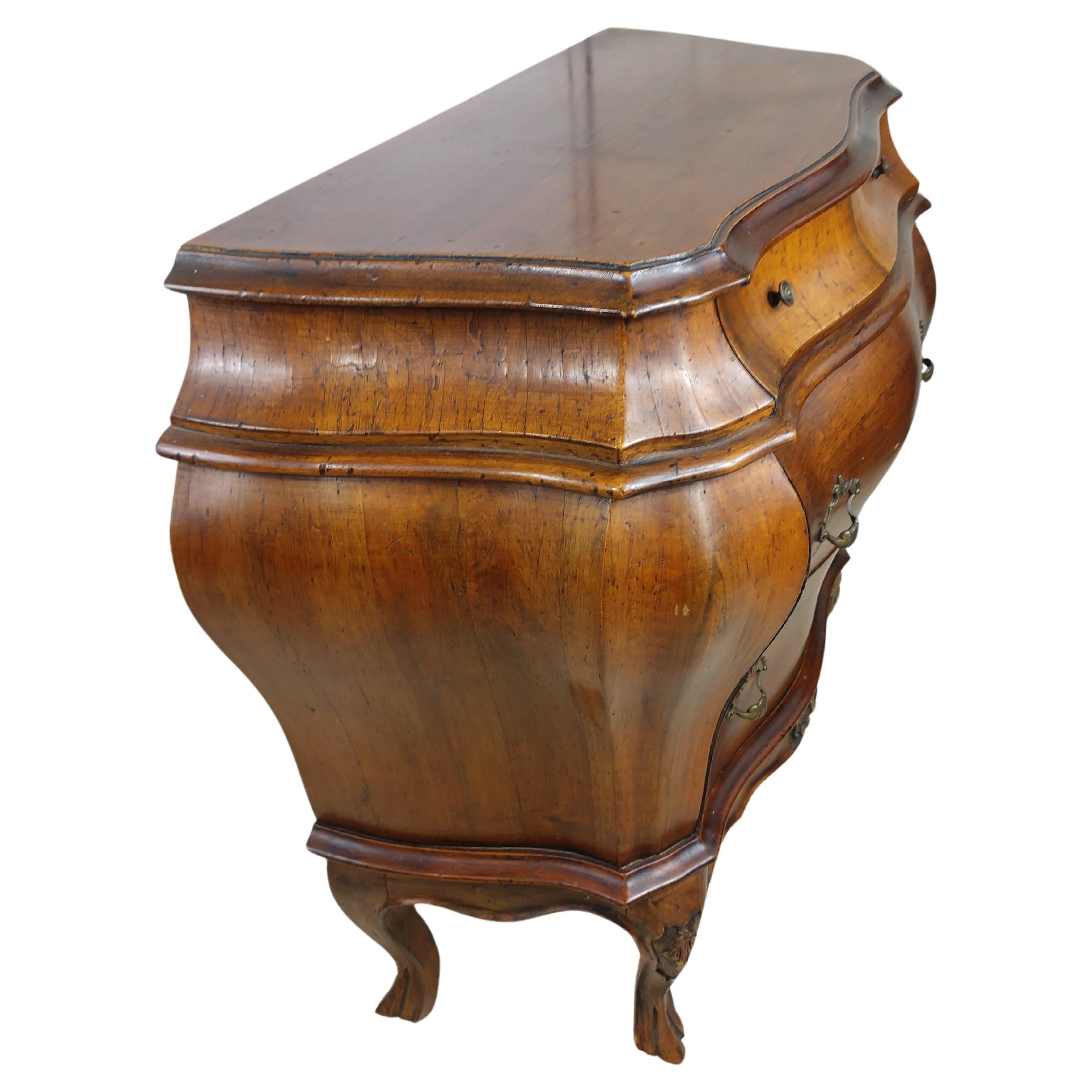 Elegant 3 drawer Rococo style bombe chests perfect for bedside or a living room. Created from walnut and in excellent vintage condition with minimal wear. Beautiful curves with original hardware and finish.