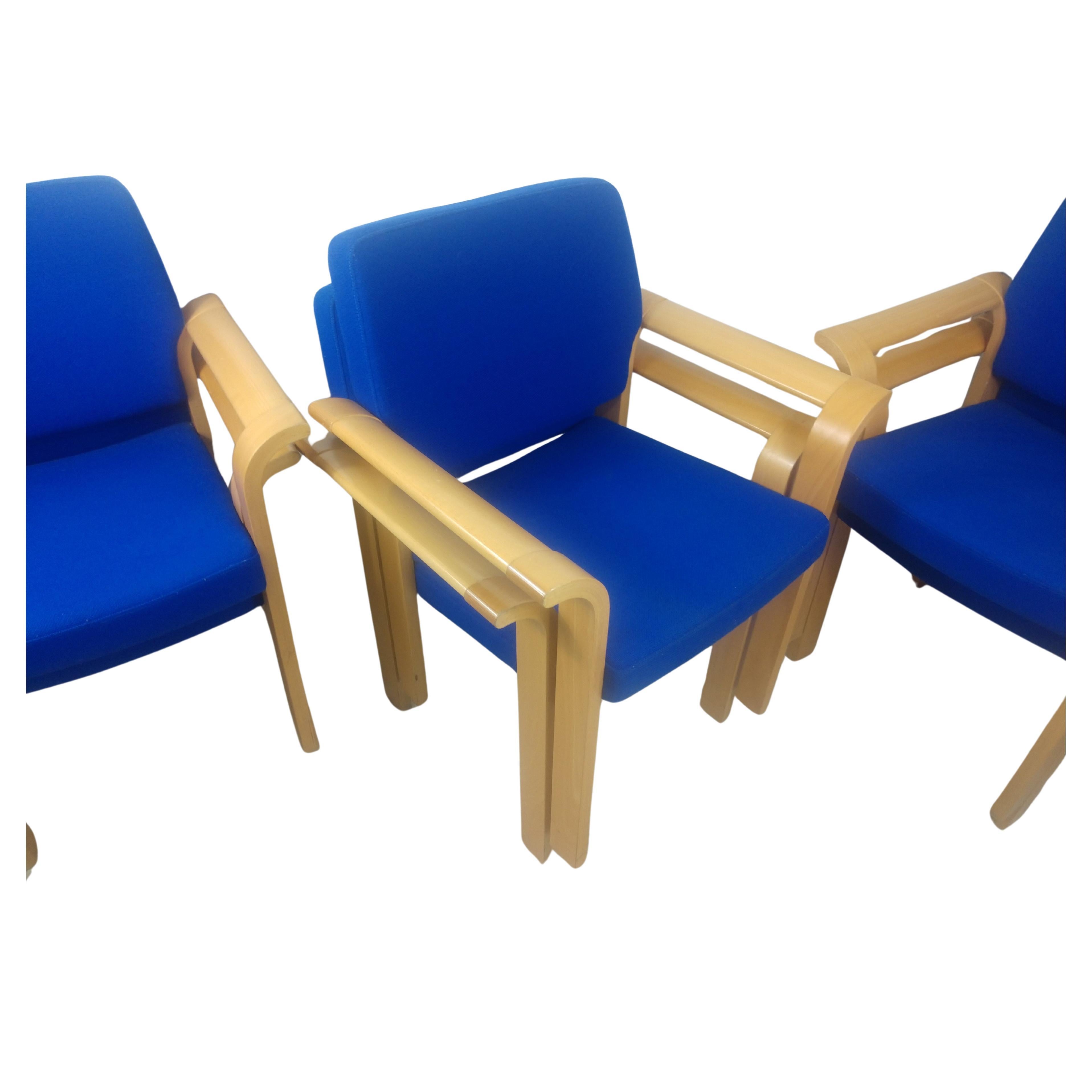 Fabulous set of mid-century oak dining conference chairs that stack. Flared bentwood arms created out of white oak and upholstered in a blue Knoll like fabric. Designed by Rud Thygesen and Johnny Sorensen for Magnus Olsen. Chairs are labelled. Seat