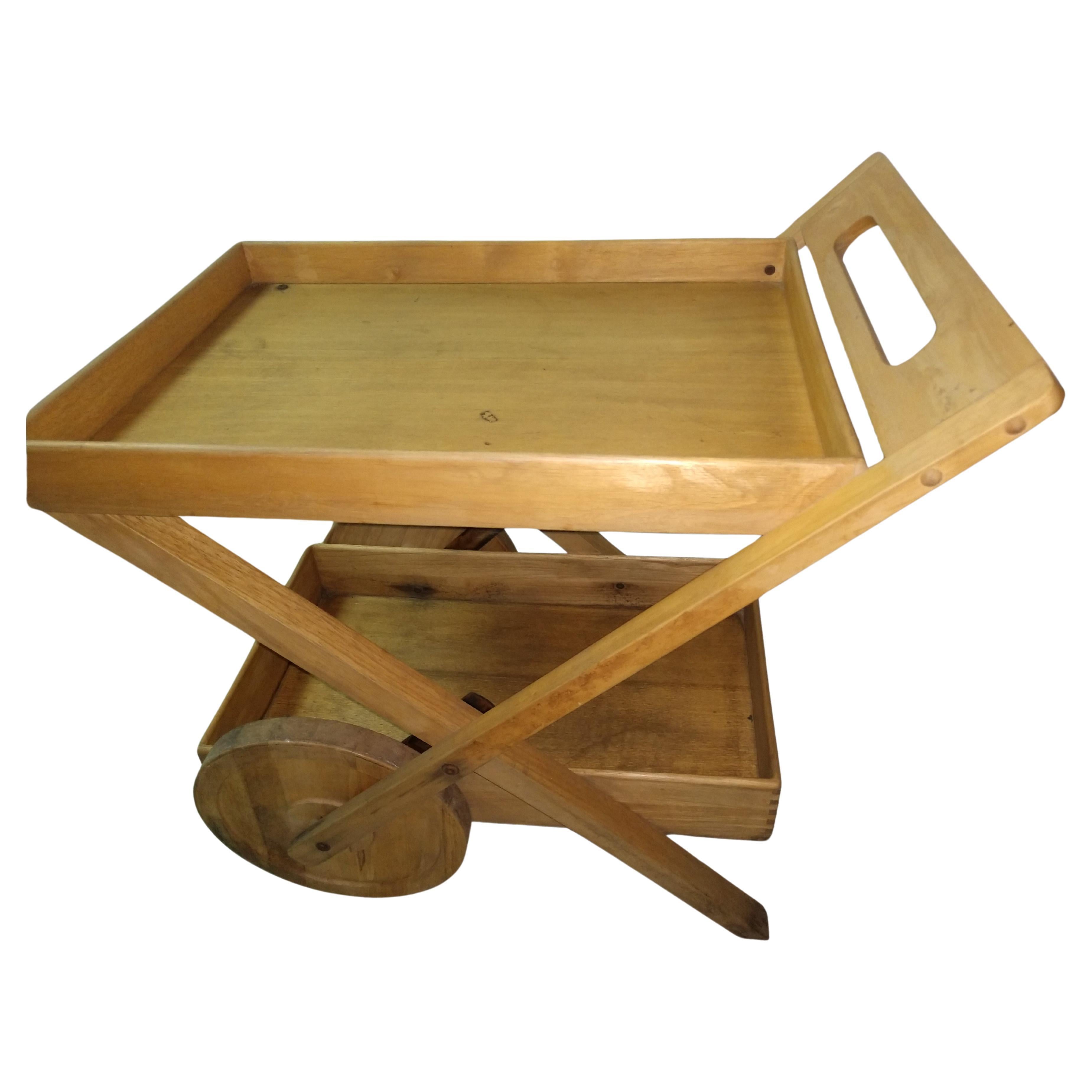 Totally fabulous teak bar cart by Jens Quistgaard for Dansk. Fixed trays are 19.5 x 27.5 and 15.5 x 28.
Teak so it can withstand the elements outdoors. Large wheels roll effortlessly. This seems to be a rare piece as I have not found another. In