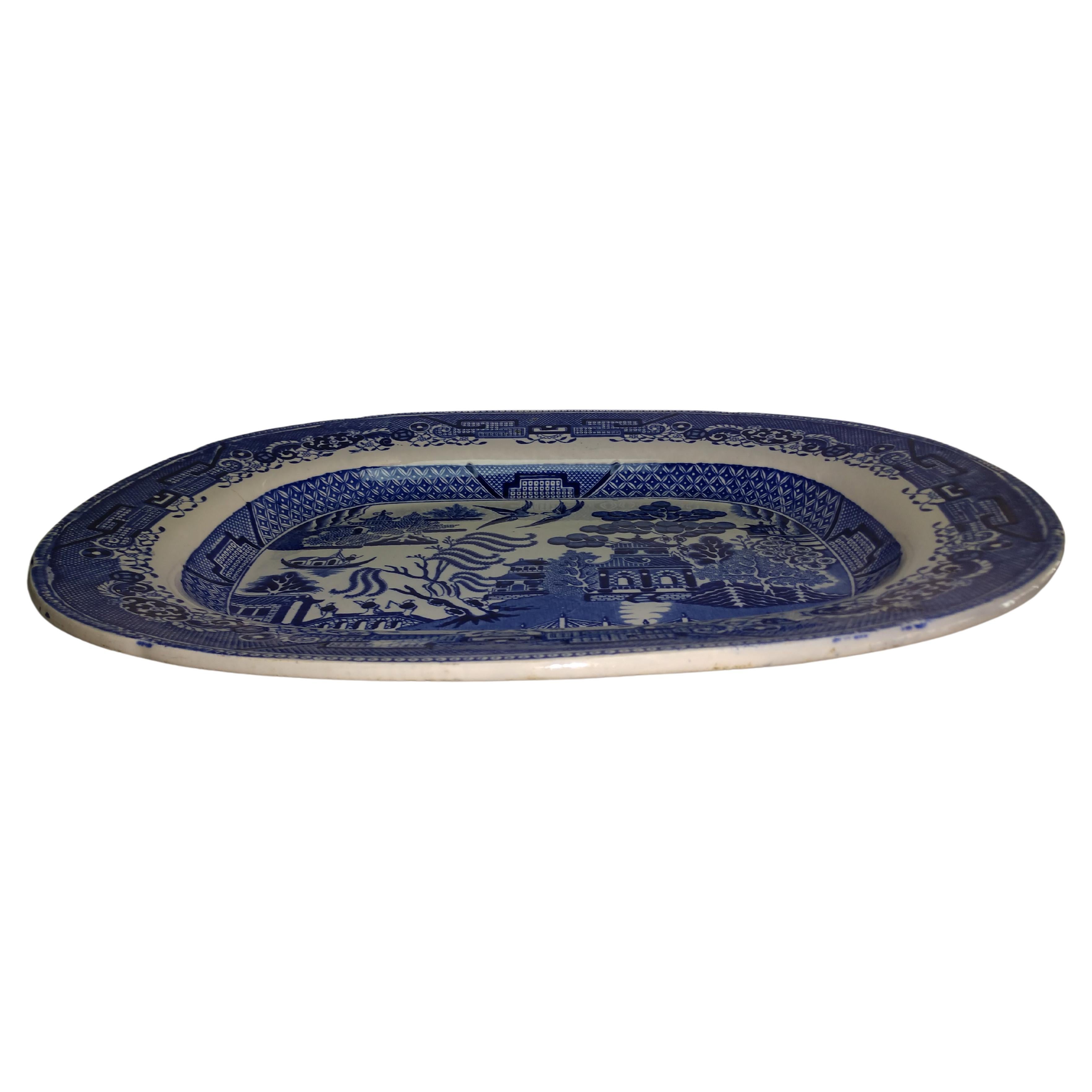 Fabulous deep and large blue willow platter from England. Late 19th century in excellent condition with no damage, chips or cracks. Excellent color retention. The best serving platter in blue willow that you will find.