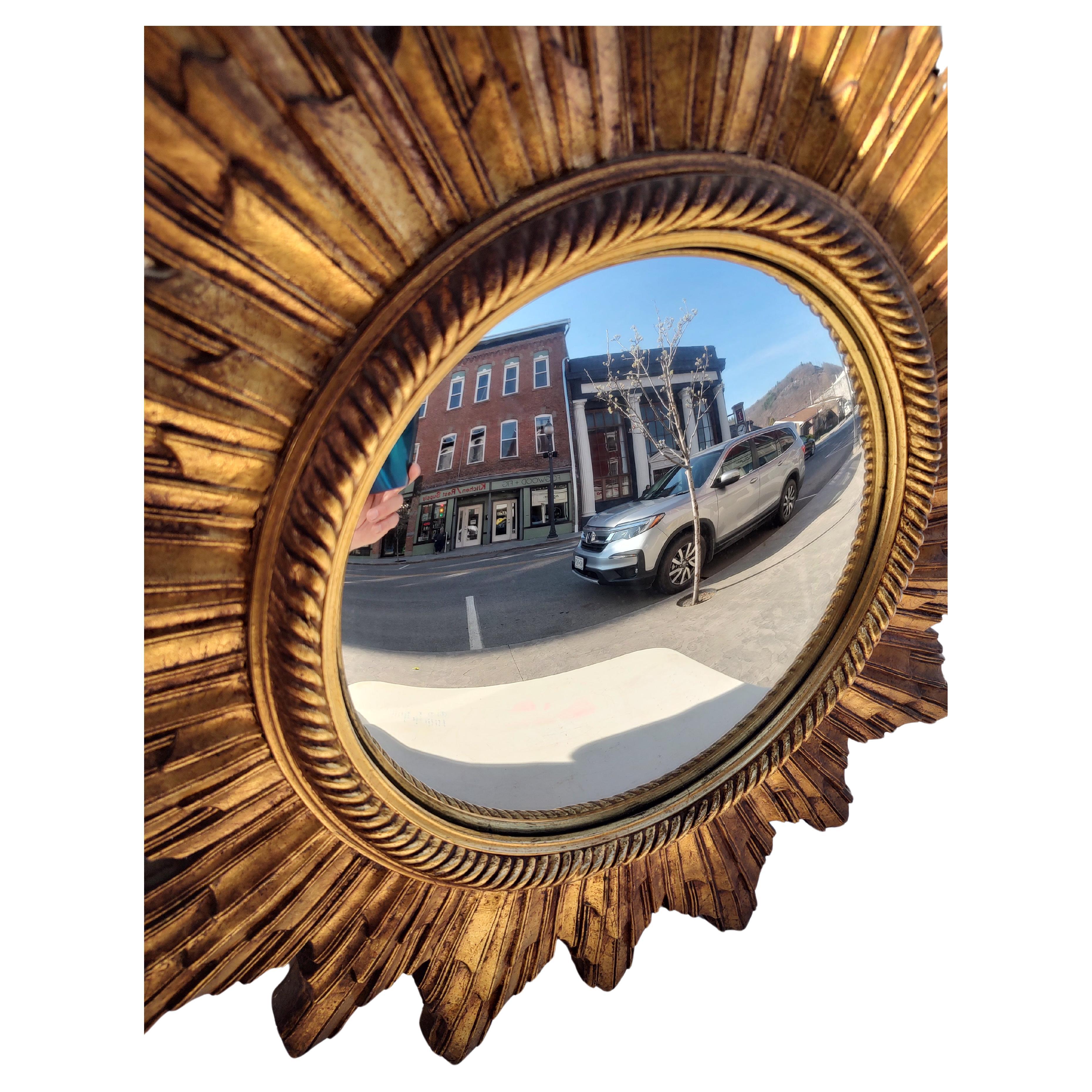 Wonderful hand carved giltwood convex mirror. In excellent vintage condition with minimal wear, see pics. 24 inch total diameter with a 11 inch convex mirror.