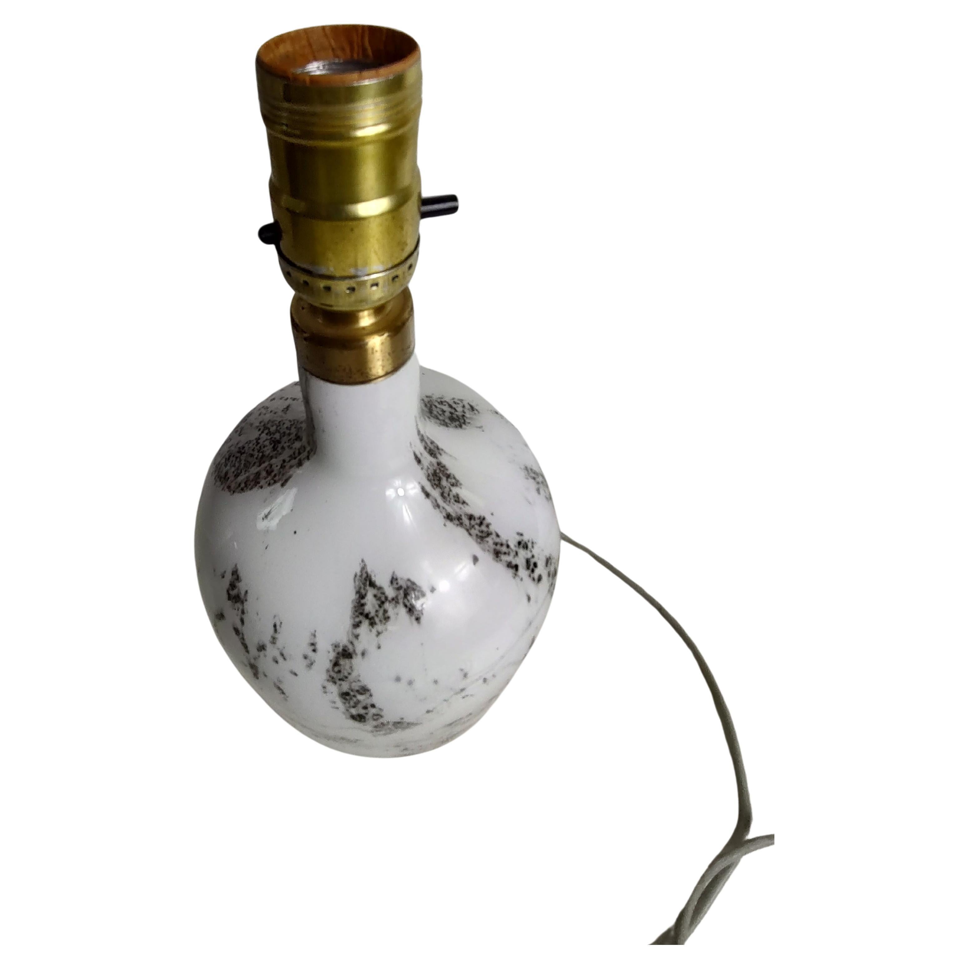 Fabulous petite hand blown art glass lamp in a squat bottle form. In excellent vintage condition with no wear. Switch on cord as well as socket.