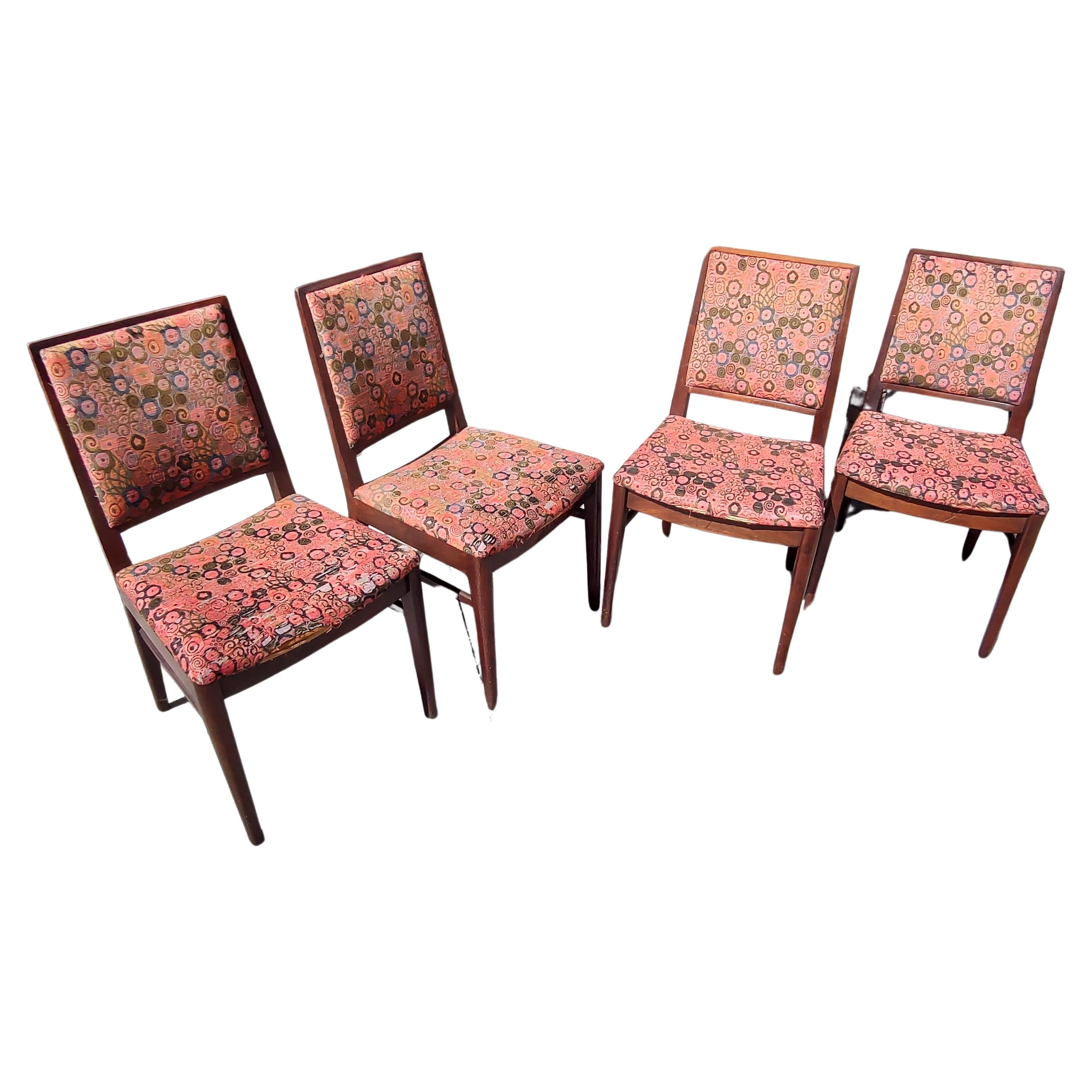 Fabulous set of 4 walnut dining chairs with Jack Lenor Larsen fabric. Fabric is worn at the front edge on 3. Otherwise good vintage condition. Walnut is near perfect with minor scuffs.