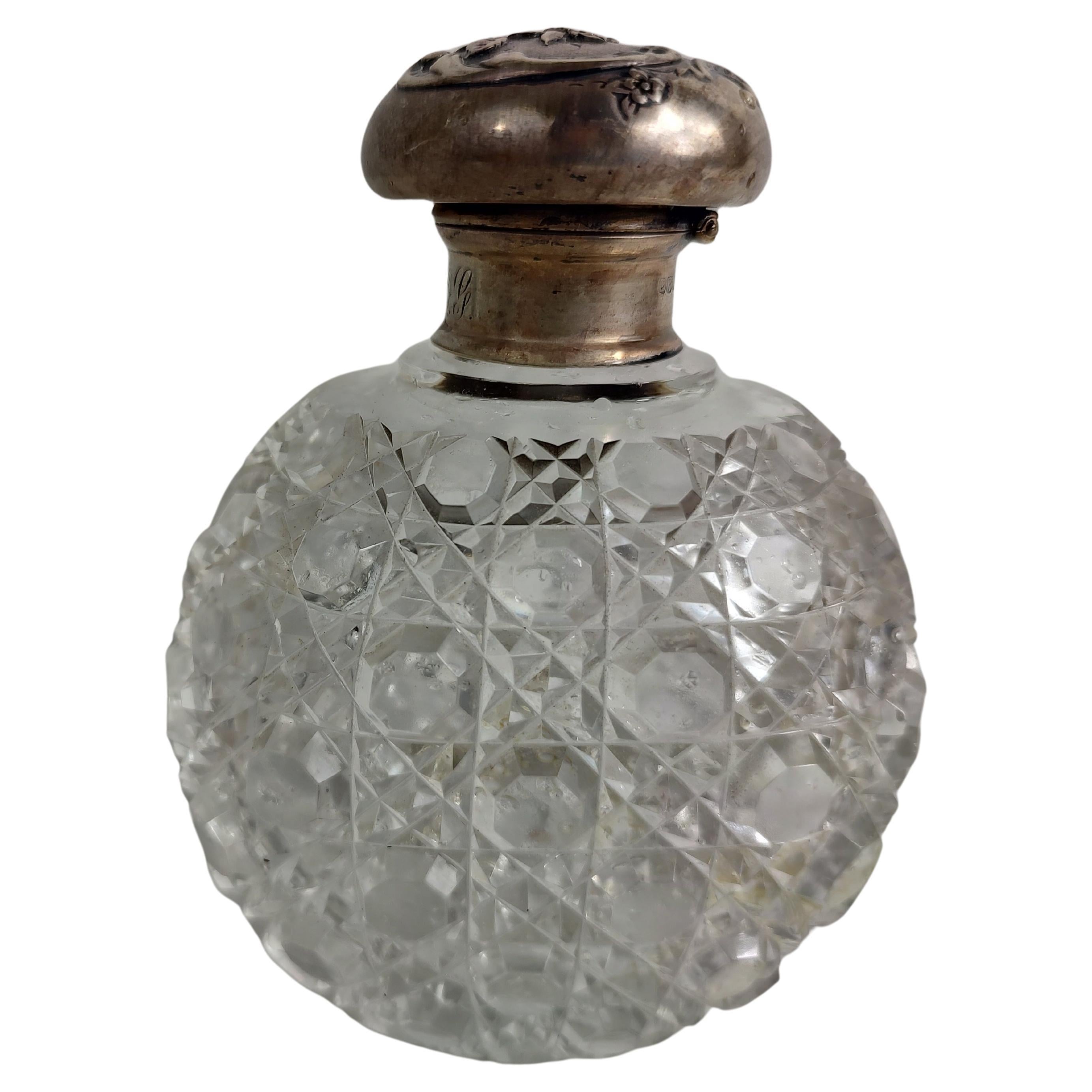 Fabulous heavy brilliant cut glass perfume bottle with sterling silver top. Has a glass stopper as well. In excellent antique condition with minimal wear. Marked sterling with hallmarks. Unpolished.