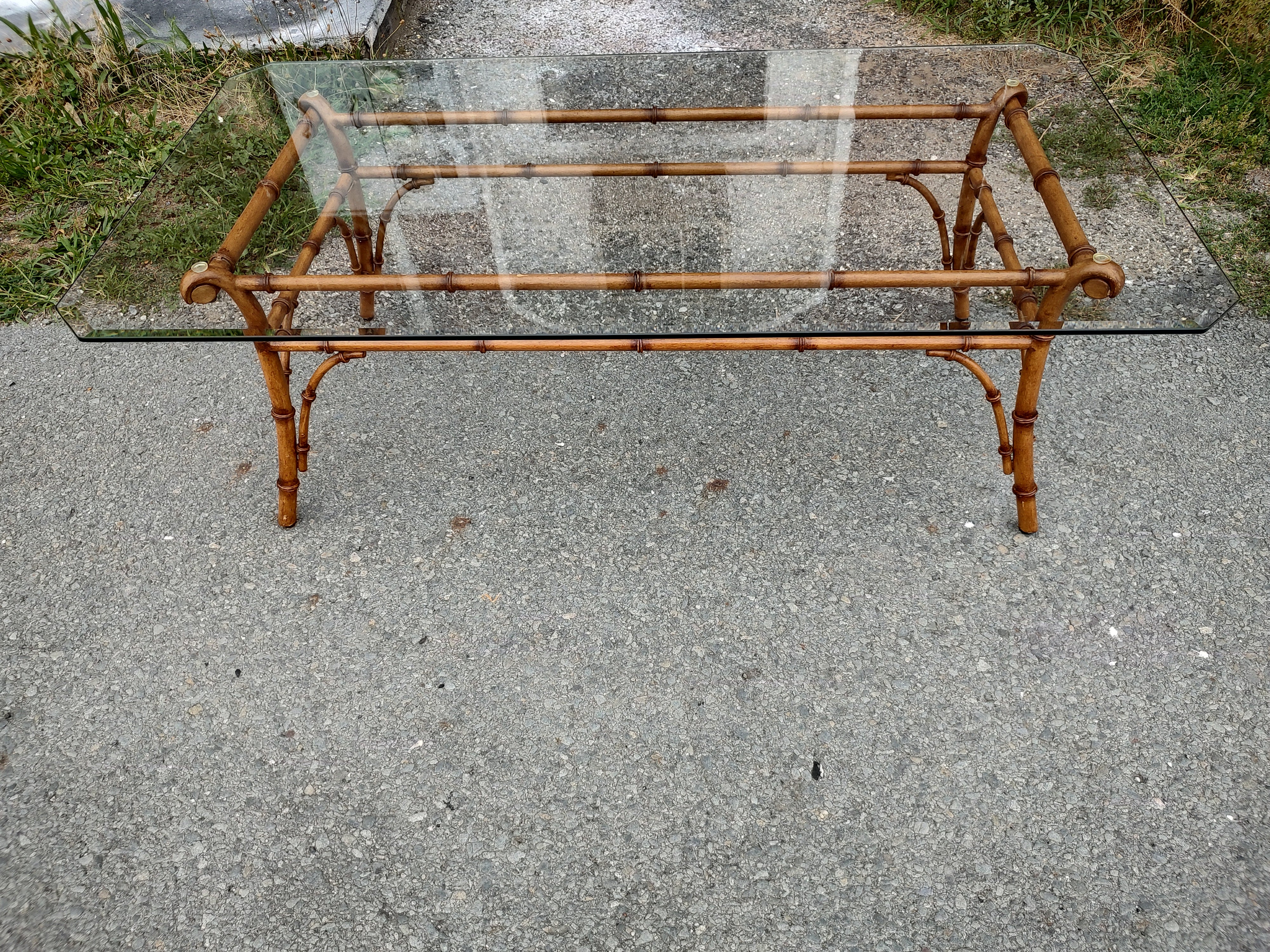 Fabulous faux bamboo cocktail table with the real bamboo look. Frame is metal, but it resembles bamboo very well. Beveled Glass Top sits flush on rubber bumpers which prevent it from shifting once in place. Quality piece.