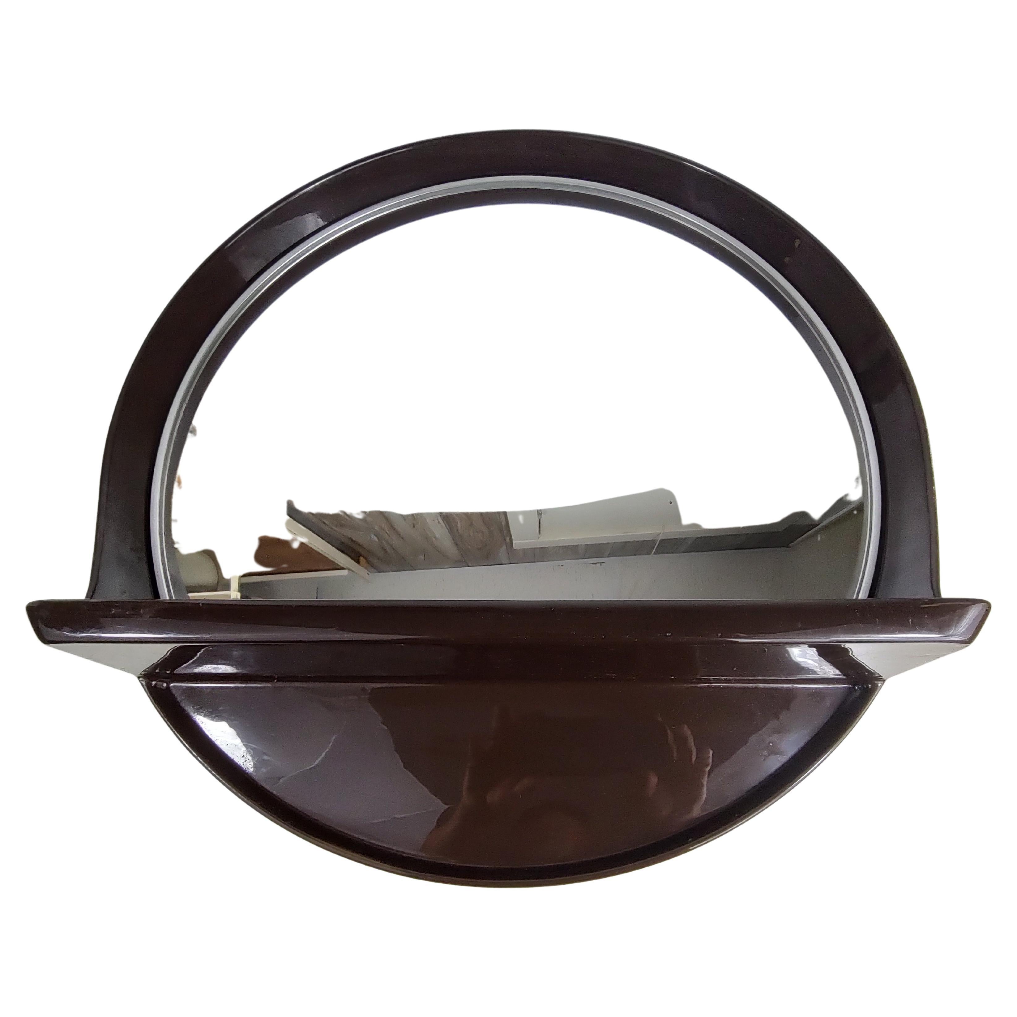 Fabulous one piece round mirror with built in shelf. In excellent vintage condition with minimal wear. Can be parcel posted. Shelf sits out about 4 inches. Labeled on back Collezione SALC Cantu Italy.
