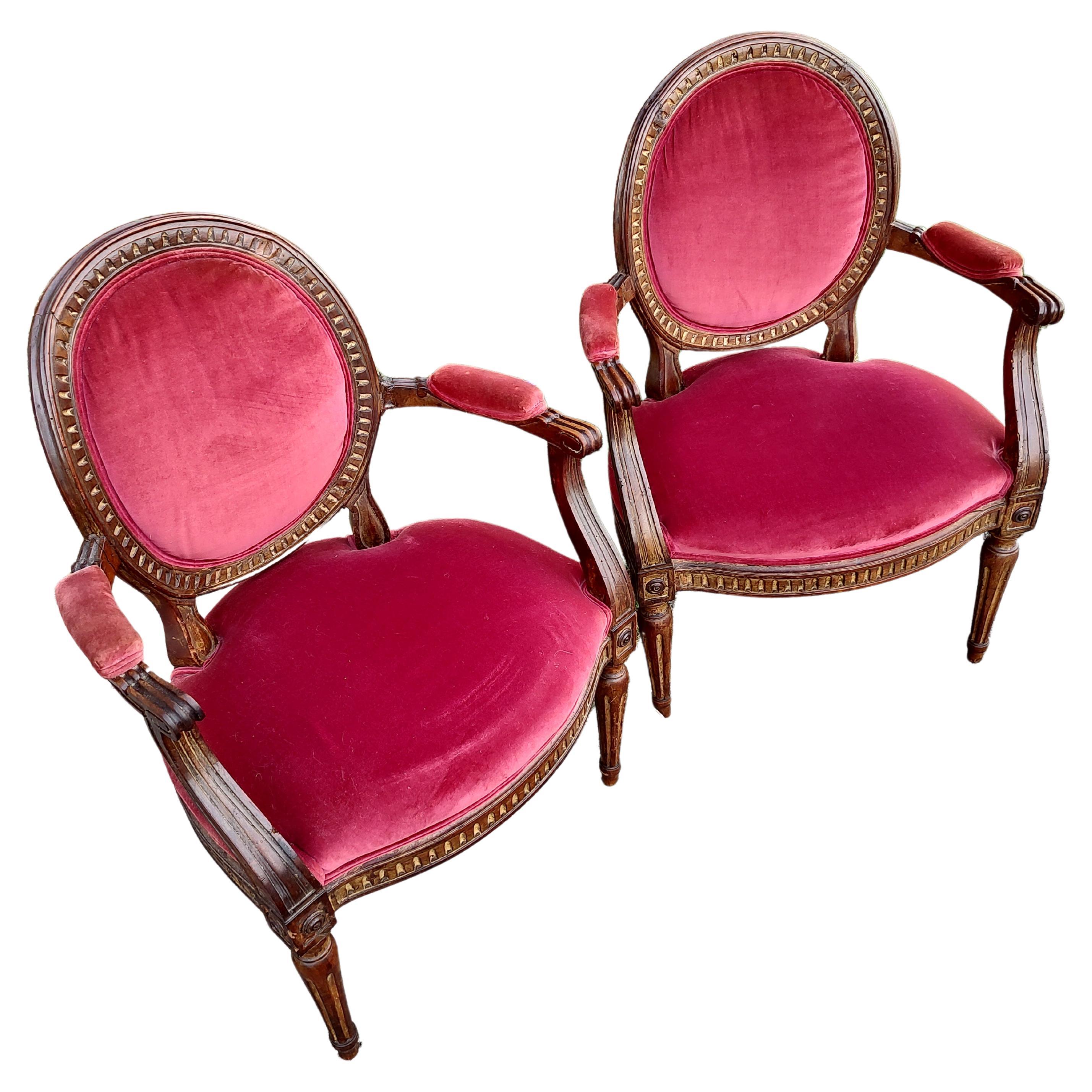 Spectacular pair of 19th Century French Fauteuils Armchairs. Hand carved with hand pegged with mortise & tenon construction. Some gilt remains. In excellent antique condition with minimal wear. Has some minor old repairs. Velvet fabric is in very