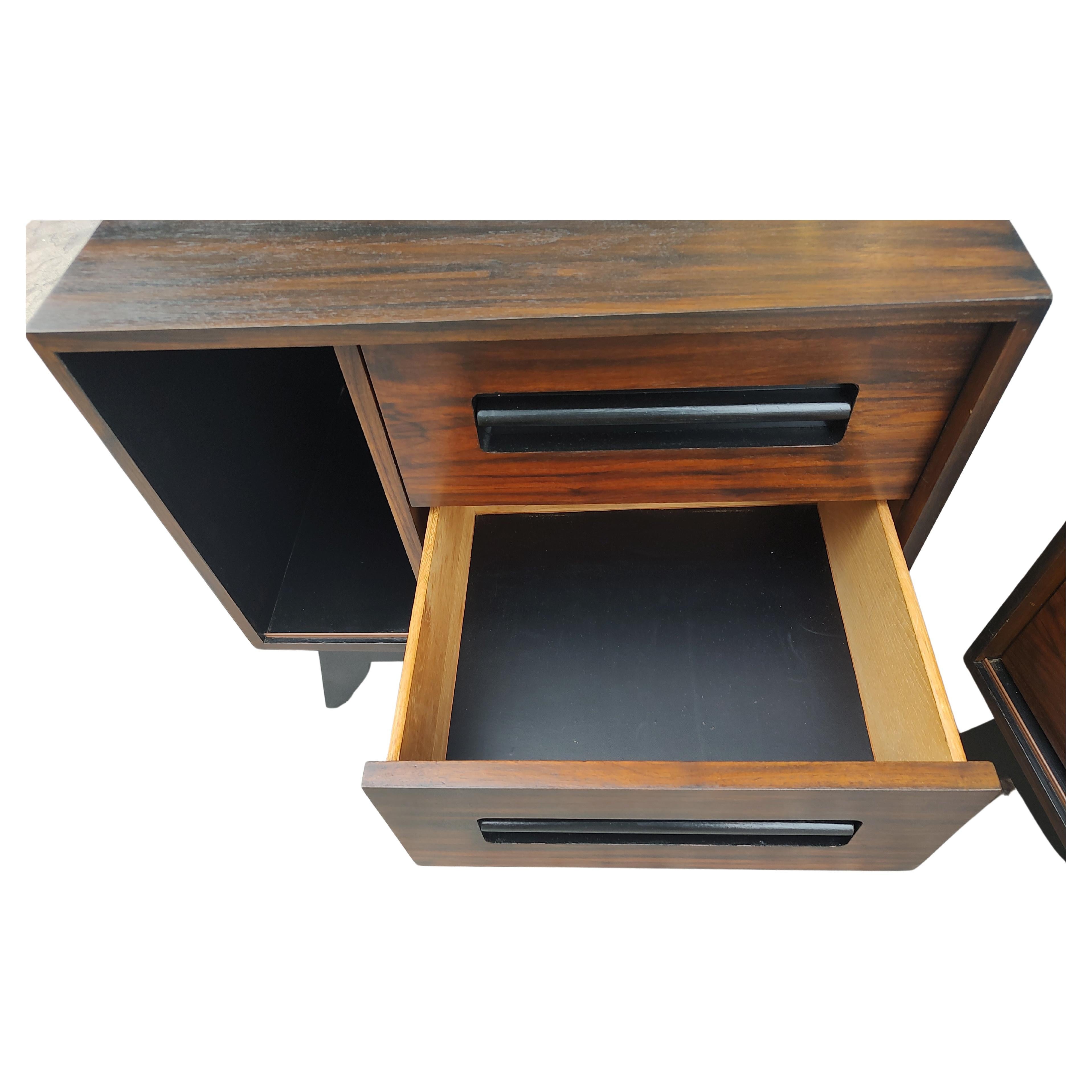 Fabulous pair of Mid-Century Modern Sculptural Scandinavian Rosewood and Black Lacquer nightstands. Two drawers & a opening for having a space at the ready. In excellent vintage condition with minimal wear. These were refinished not long ago. Sold