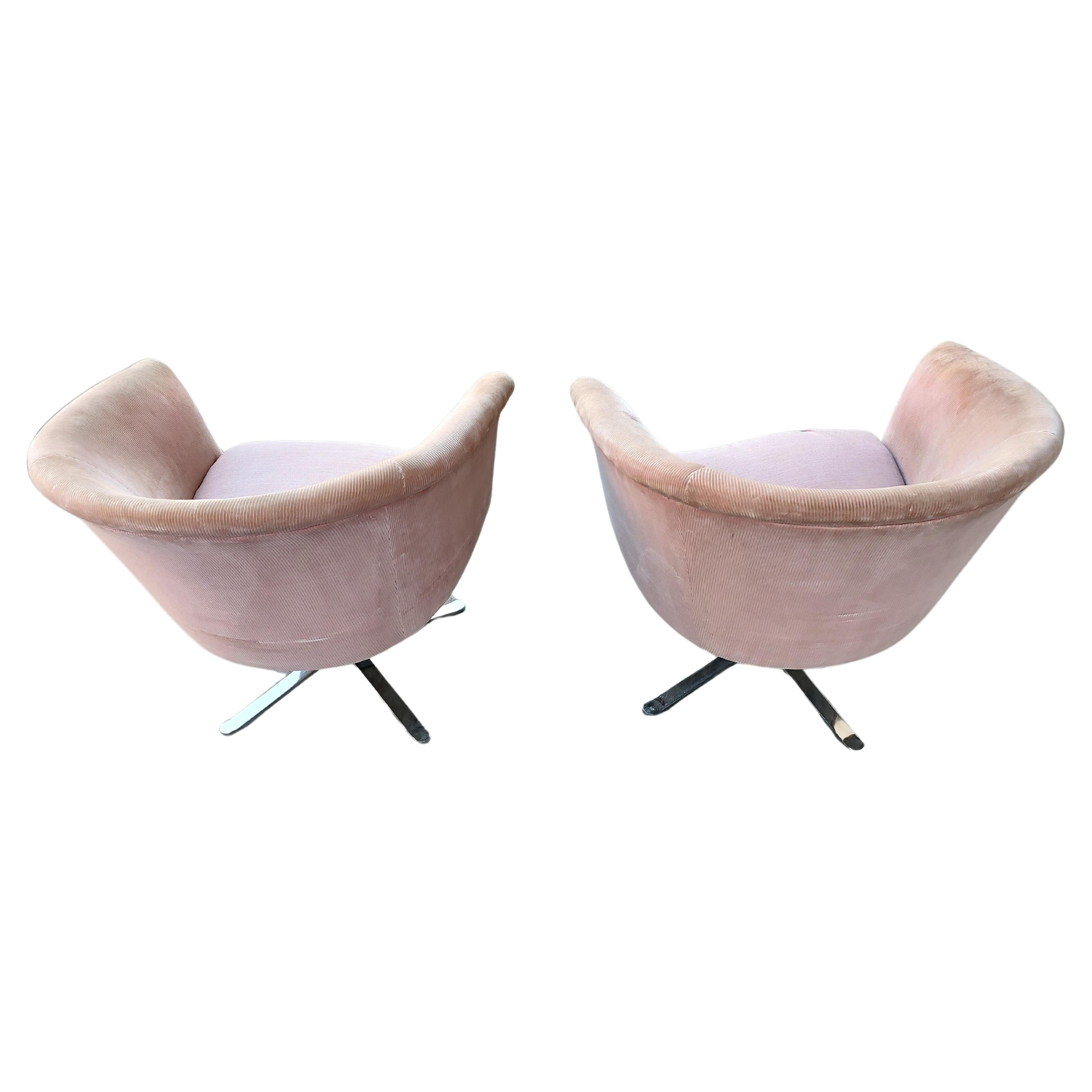Fabulous pair of barrel back swivel chairs in a dusty rose corduroy. Heavy and well designed with a chromed four leg system that balances and looks amazing. Fabric is serviceable but has faded with time and still looks good. Has a ball point pen
