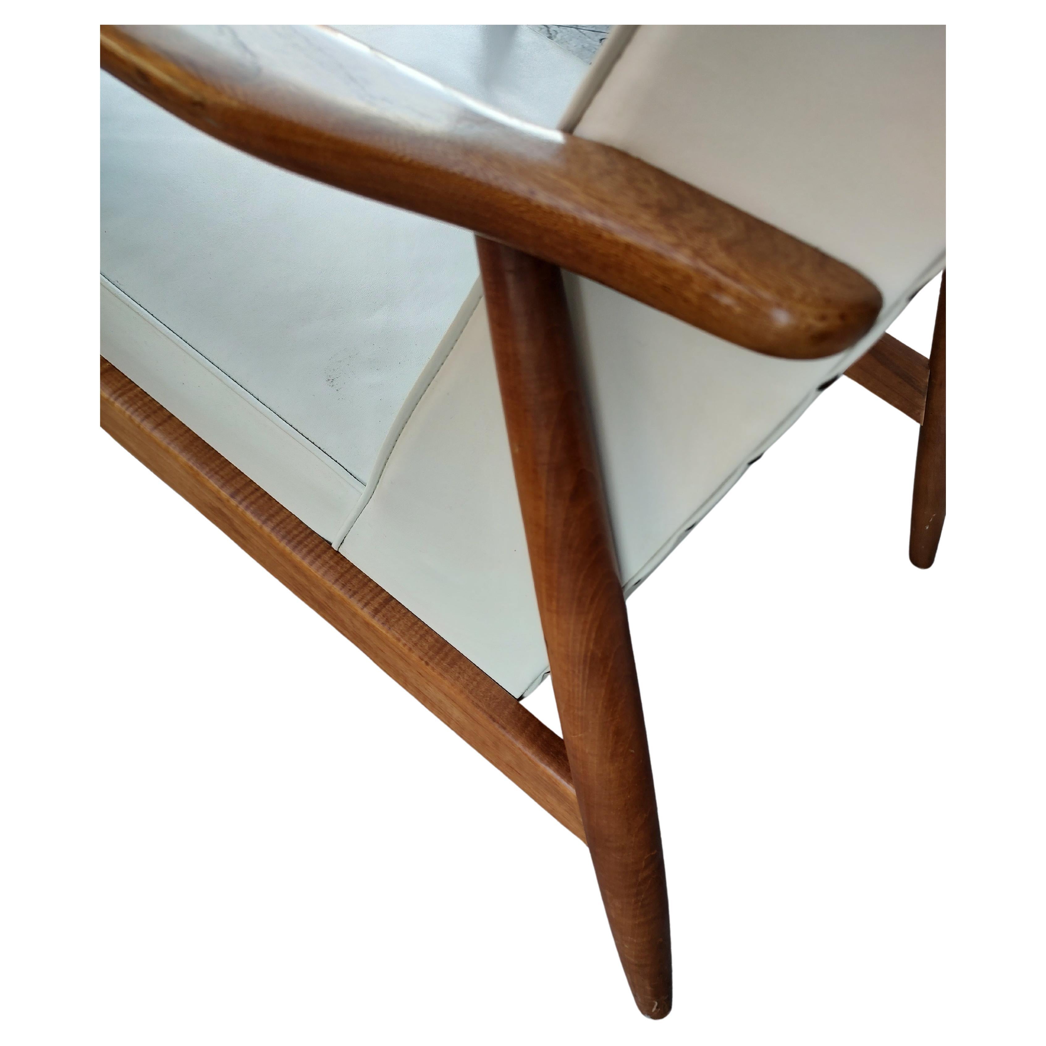 Simple and elegant and in excellent vintage condition. Naugahyde remains in top condition and is quite comfy and stylish. Walnut frame is also in like new condition.