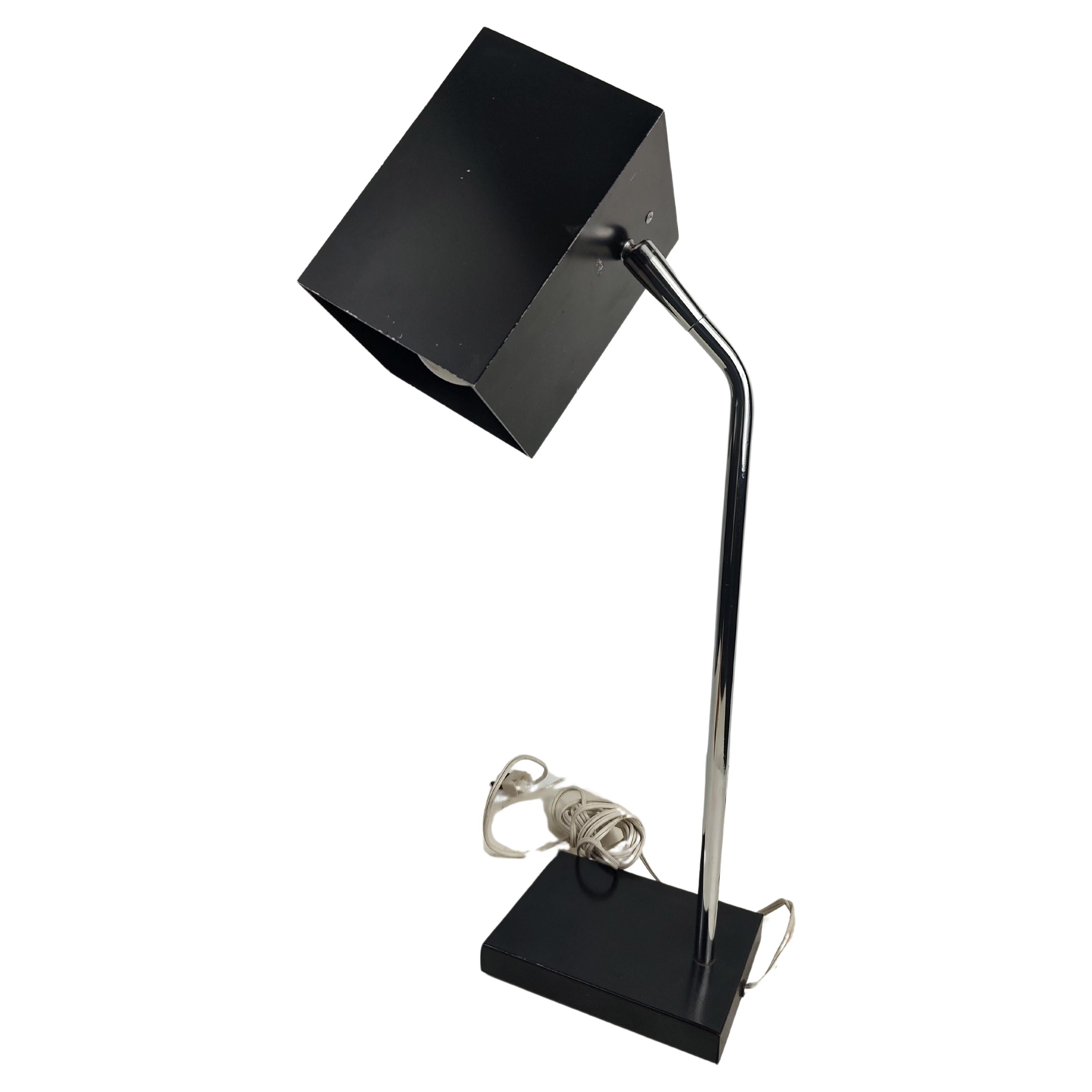 Simple elegant and so functional. Fully adjustable desk lamp by Robert Sonneman with a weighted base for stability. The Cube lamp in black with a chrome shaft in excellent vintage condition with minimal wear.