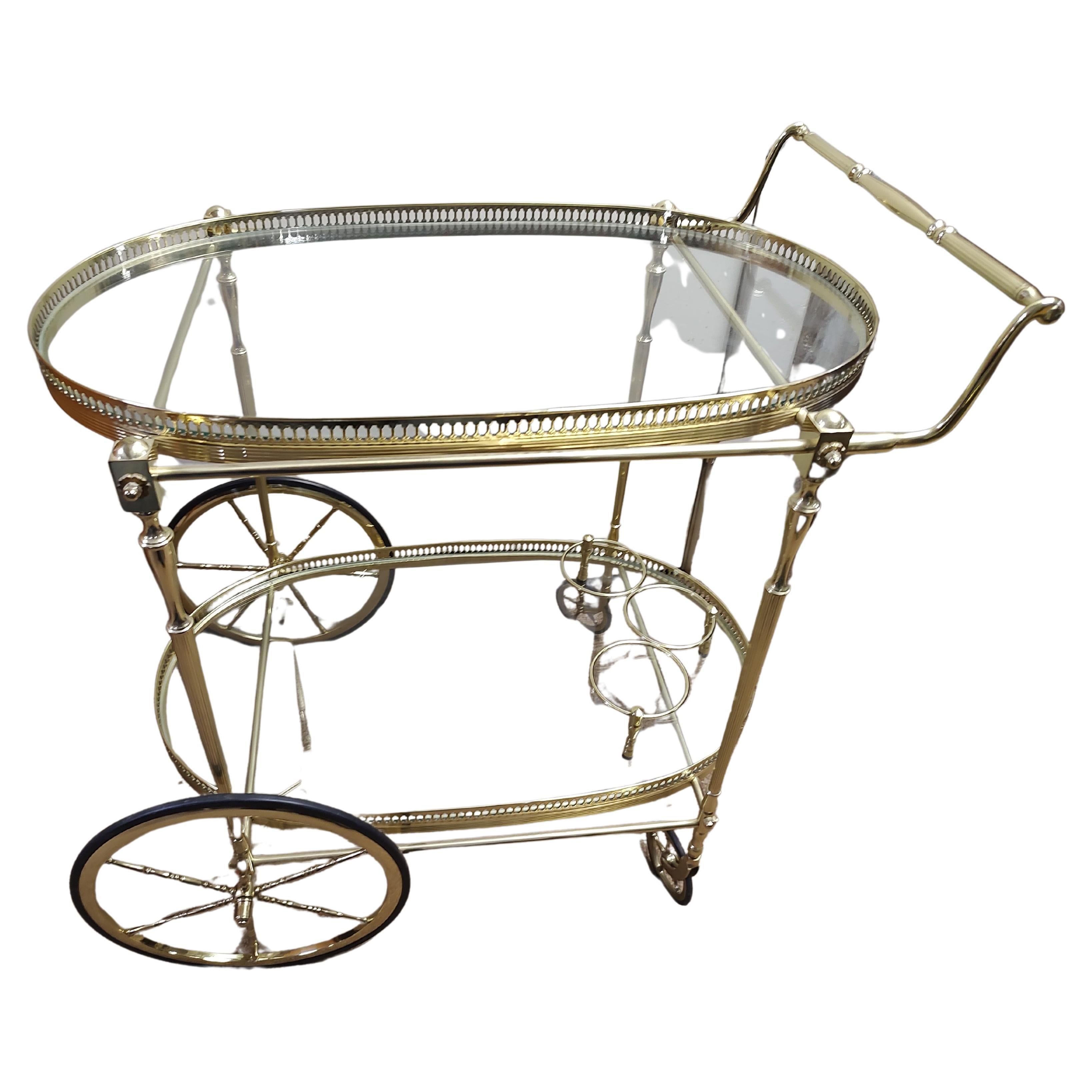 Mid Century Brass Neoclassical Bar Cart with Oval Glass Shelves For Sale