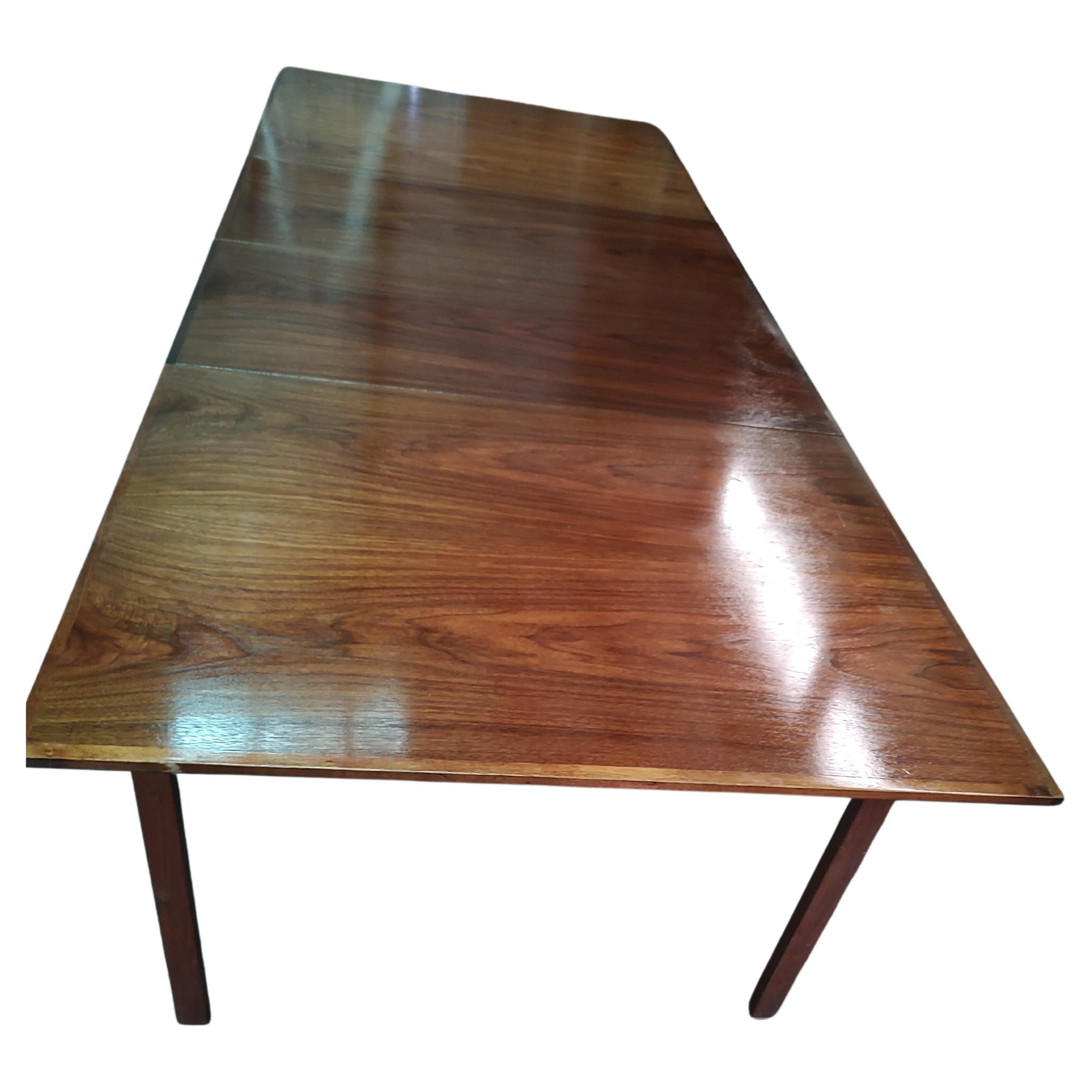 Simple and elegant black walnut dining table attributed to the Founders Furniture Company. In excellent vintage condition with minimal wear, it was well taken care of. Two large leaves 20 inch each. Table without the the leaves is 41.5 x 64. With