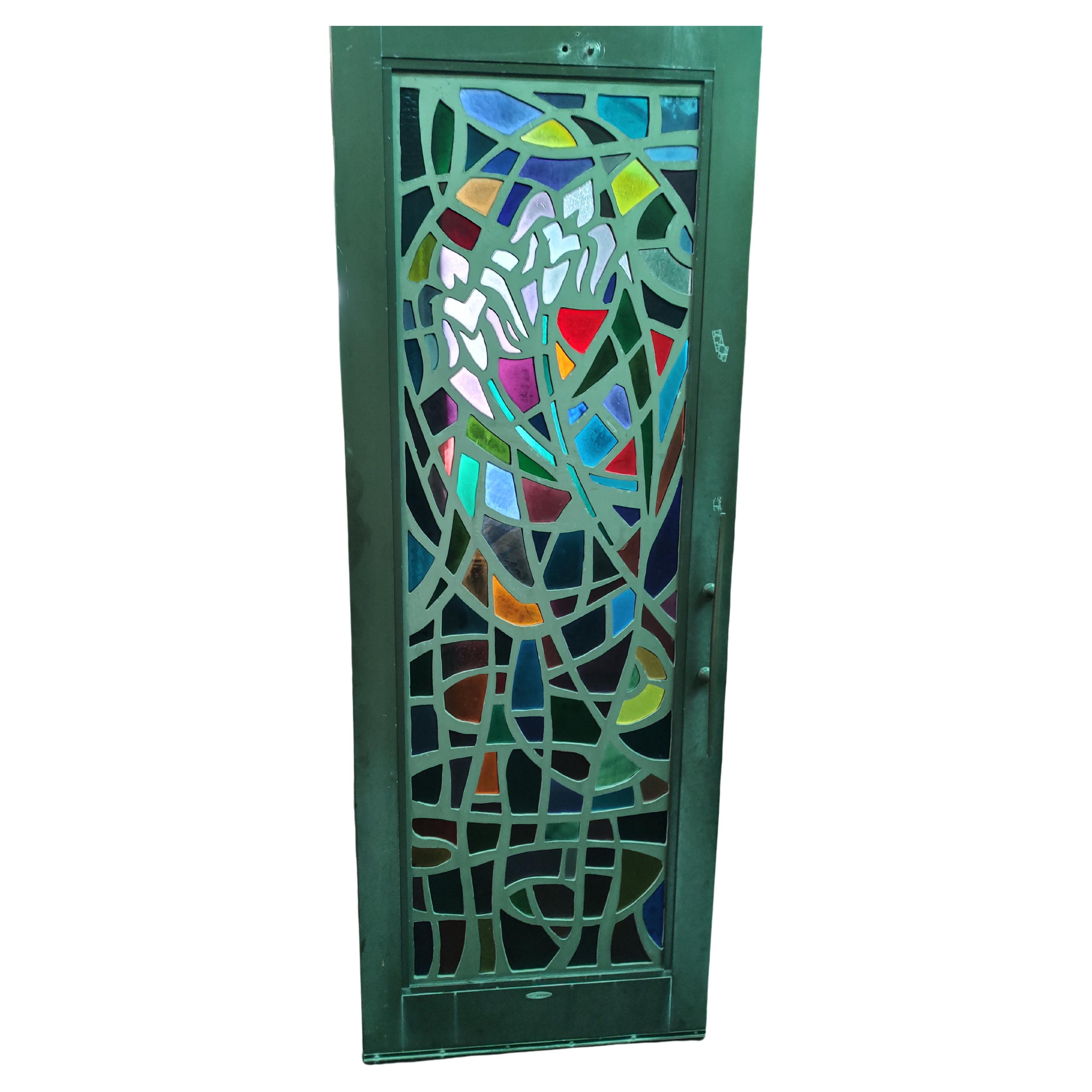 Extremely Rare set of 10 steel doors with individual and different stained glass panels, which are 23.5 x 72. Door size is 30.5 x 84 x 2. Panels can be removed. So beautiful the color absolutely pops when the light shines thru. Each one has a