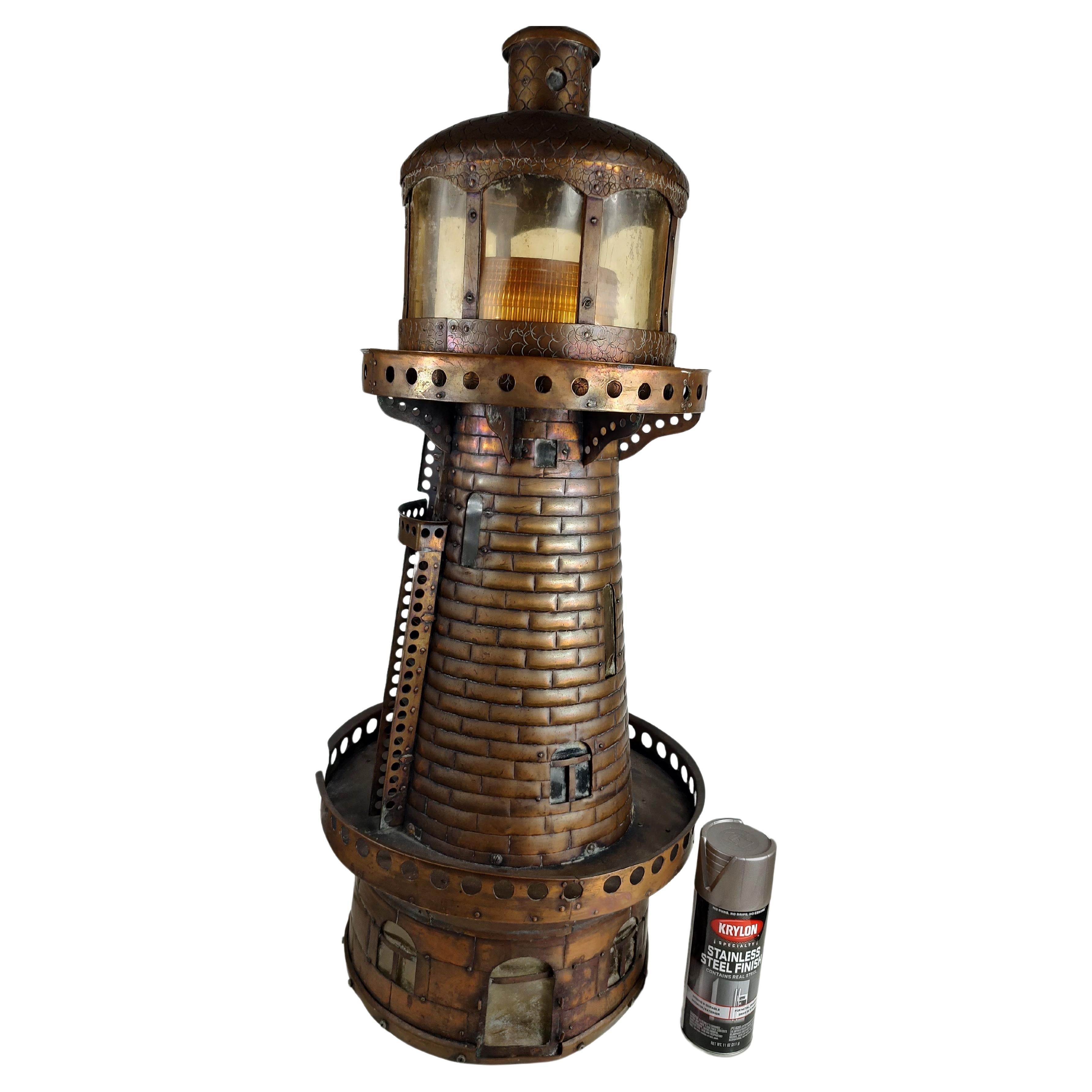 Amazing craftsmanship in this one of a kind piece hand crafted from copper. Hammered repousse in and around the entire lighthouse. Tall 33 inches by 14 diameter with an 11 inch balcony. Entirely lights up, Tower with a large dome light with a yellow