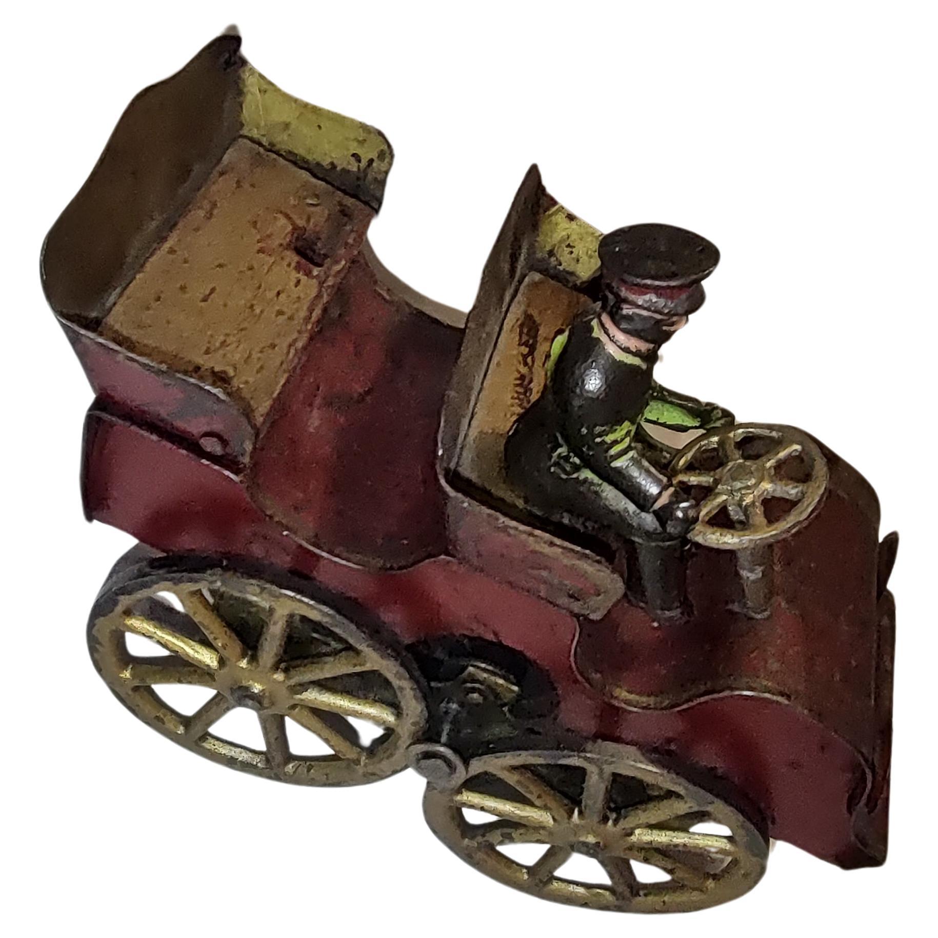 Fabulous early toy example by the Clark co. This hill climber works great, and is almost totally complete. It's missing it's passenger in the back. Cast iron chauffeur looks to be original. Created from wood & tin with some cast iron. In excellent