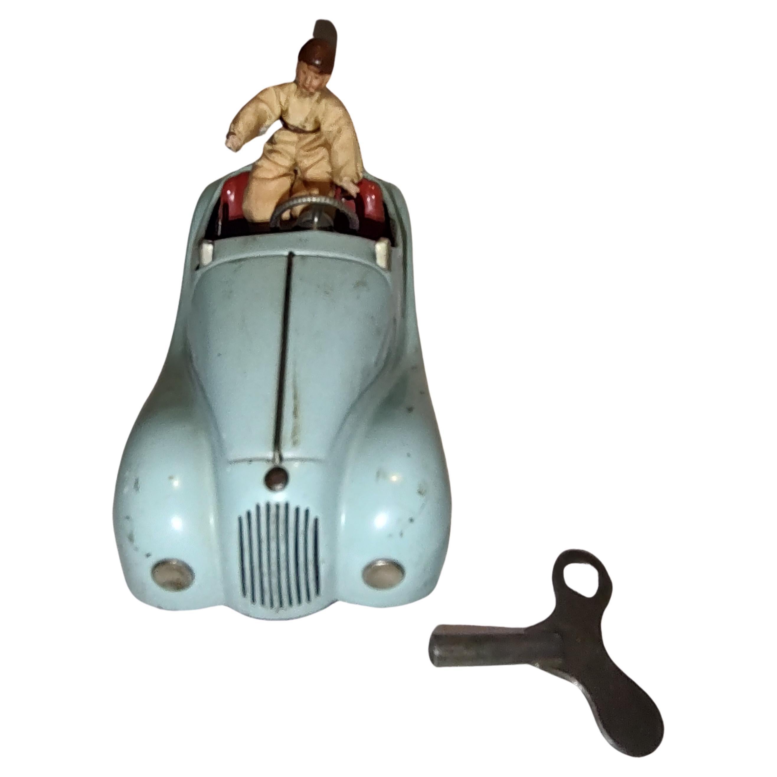 Fabulous toy windup by Schuco from the US Zone in Western Germany from the fifties. Unique toy car as it has two windup mechanisms, one to power the car, and the other for the Horn which honks. Has a gear shifter and the steering wheel turns the