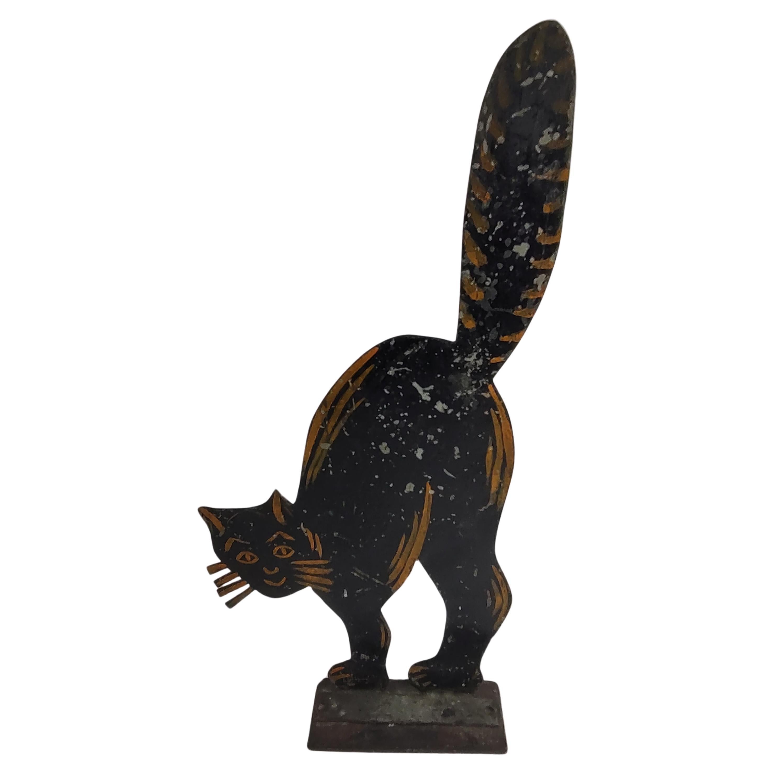 Fabulous and rare painted sheet metal black cat with arched back and prominent whiskers door stop. Measures : Tall 23 x 10.75 so it makes it's presence felt. Very cool cat! In original paint with some chips.