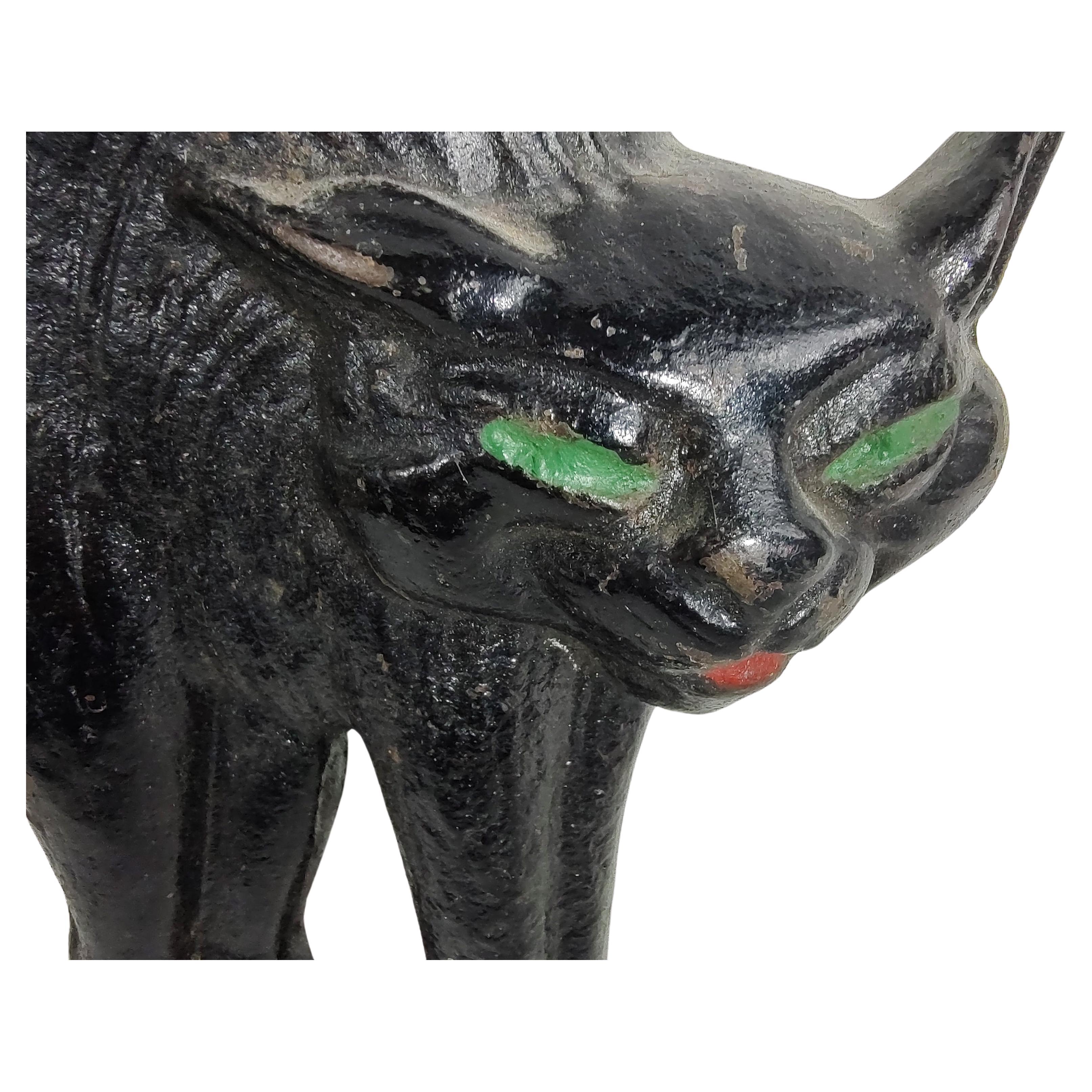 Fabulous stylized cast iron cat with arched back possibly hissing. Hand painted and a rare form from the Art Deco period. In excellent vintage condition with minimal wear.