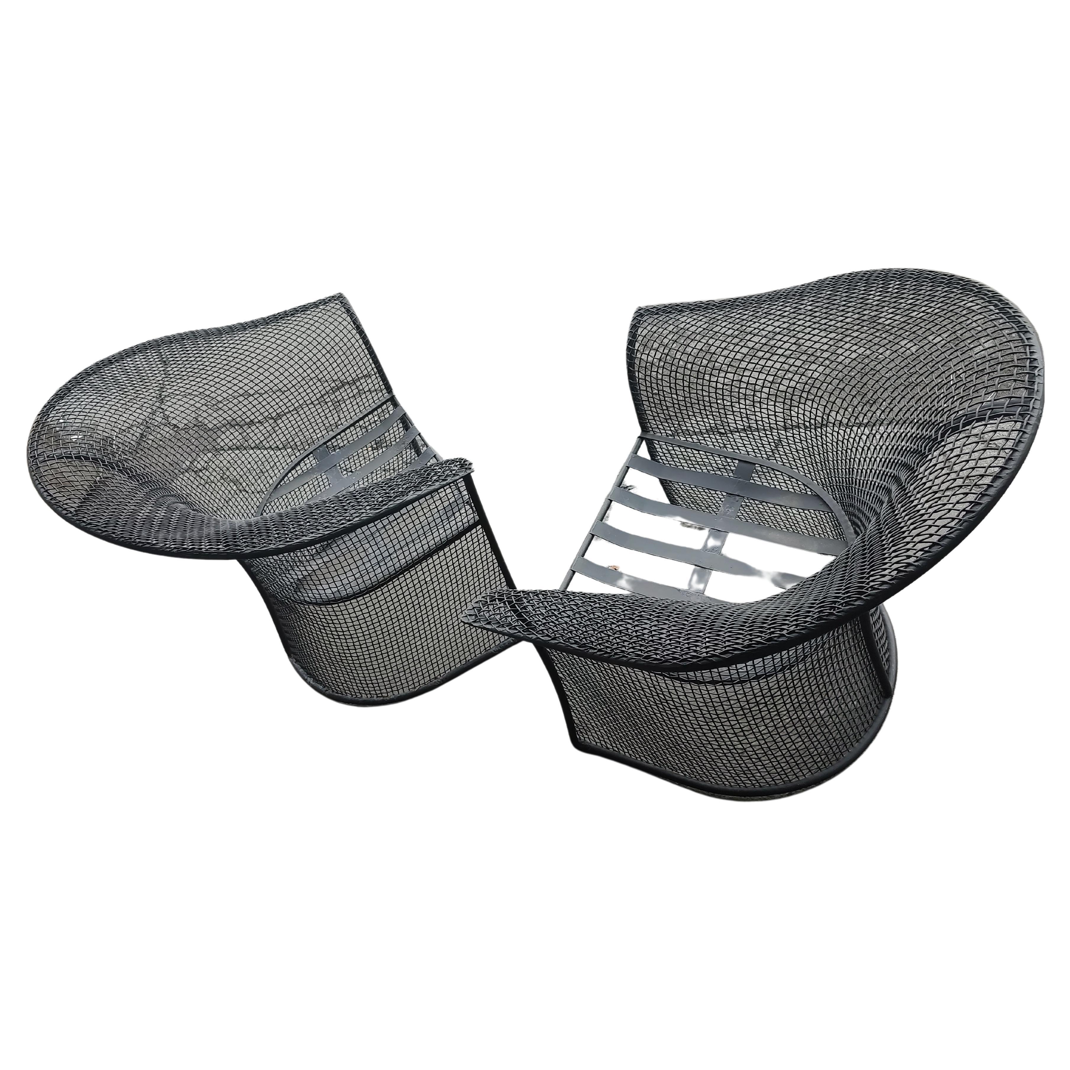Rare and fabulous pair of Mid-Century Modern sculptural mesh lounge chairs in an unusual form. 
Painted black and with removable seat cushions. In excellent vintage condition, no damage, unrestored.