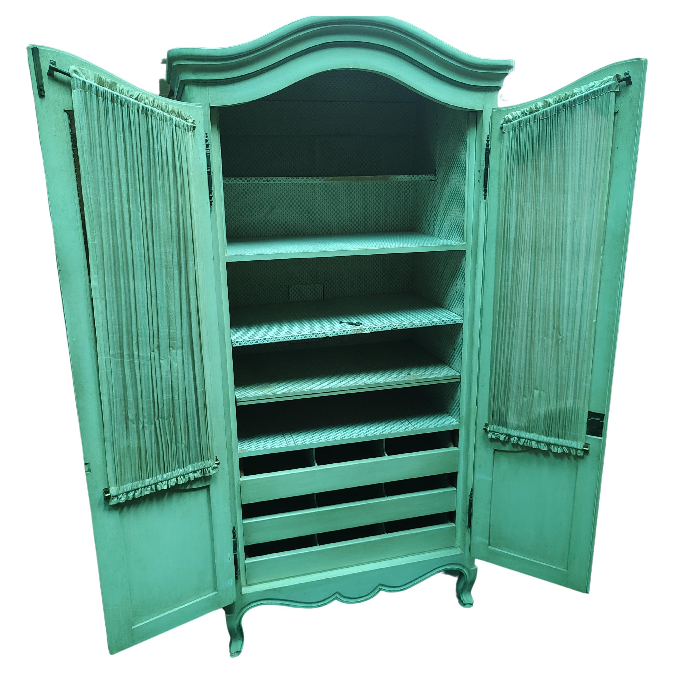 It's White not green. Spacious French Provincial armoire painted white with green accents. Plenty of storage with 5 adjustable shelves and 3 pullout drawers with dividers. Brass hardware, open style doors with screen mesh and curtains, (old need