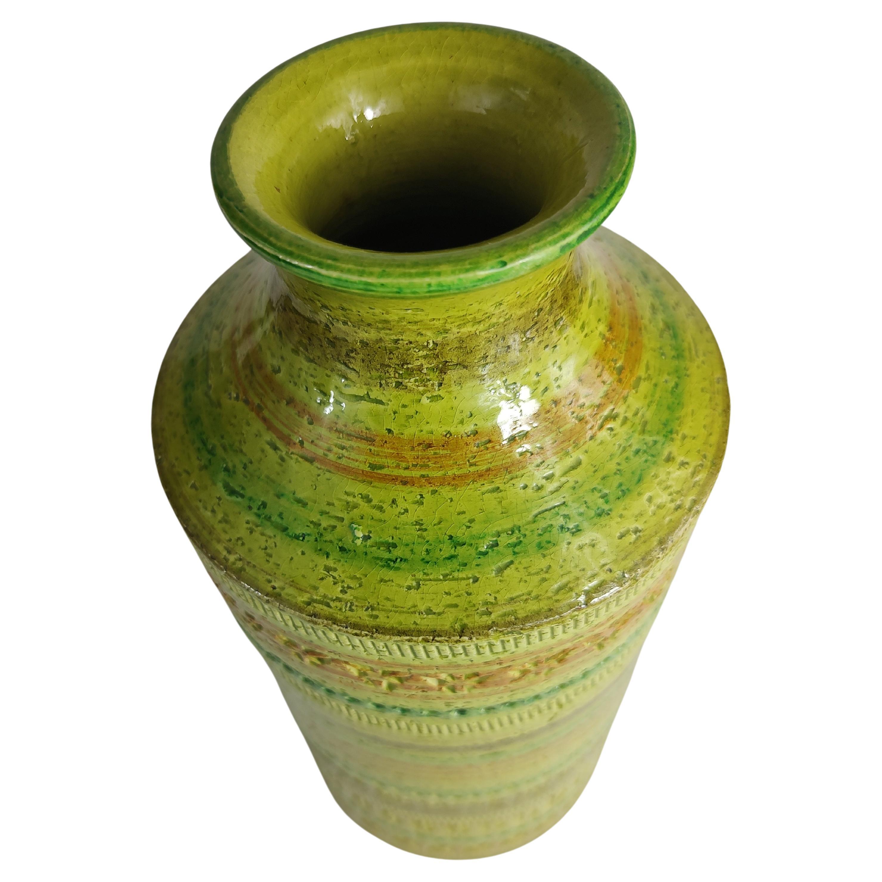 Fabulous and beautiful vase in lime green with concentric stripes in various colors with archaic impressions banding the perimeter. Aldo Londi for Bitossi vase , 12.5 x 5.5 in diameter. Fantastic crafting, amazing color! In excellent vintage