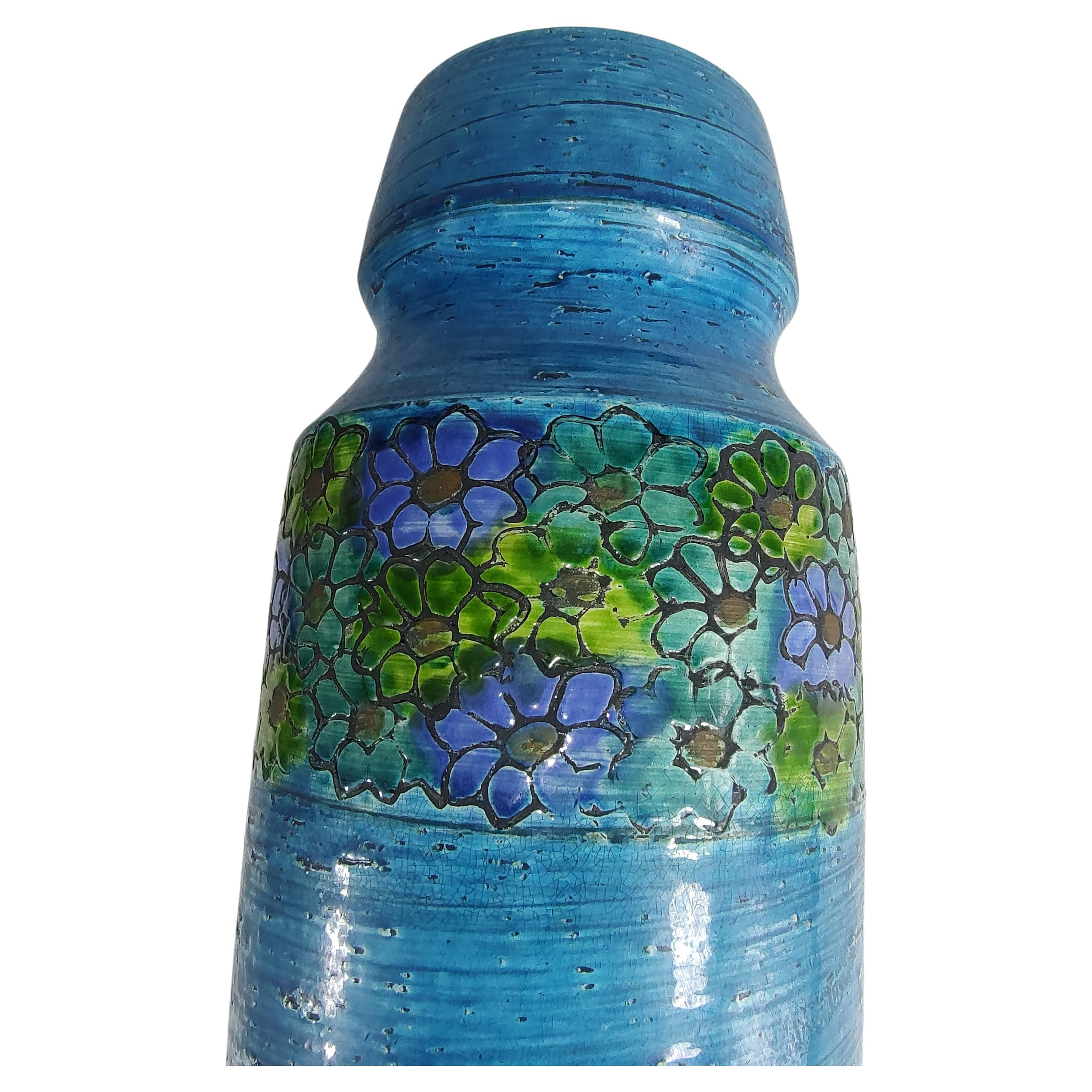 Fabulous tall vase by Aldo Londi designer for Bitossi of Italy. Amazing color, Rimini Blue with a band of flowers circling the upper portion of the vase. In excellent vintage condition with no chips or cracks. Such a serene piece of art! Signed