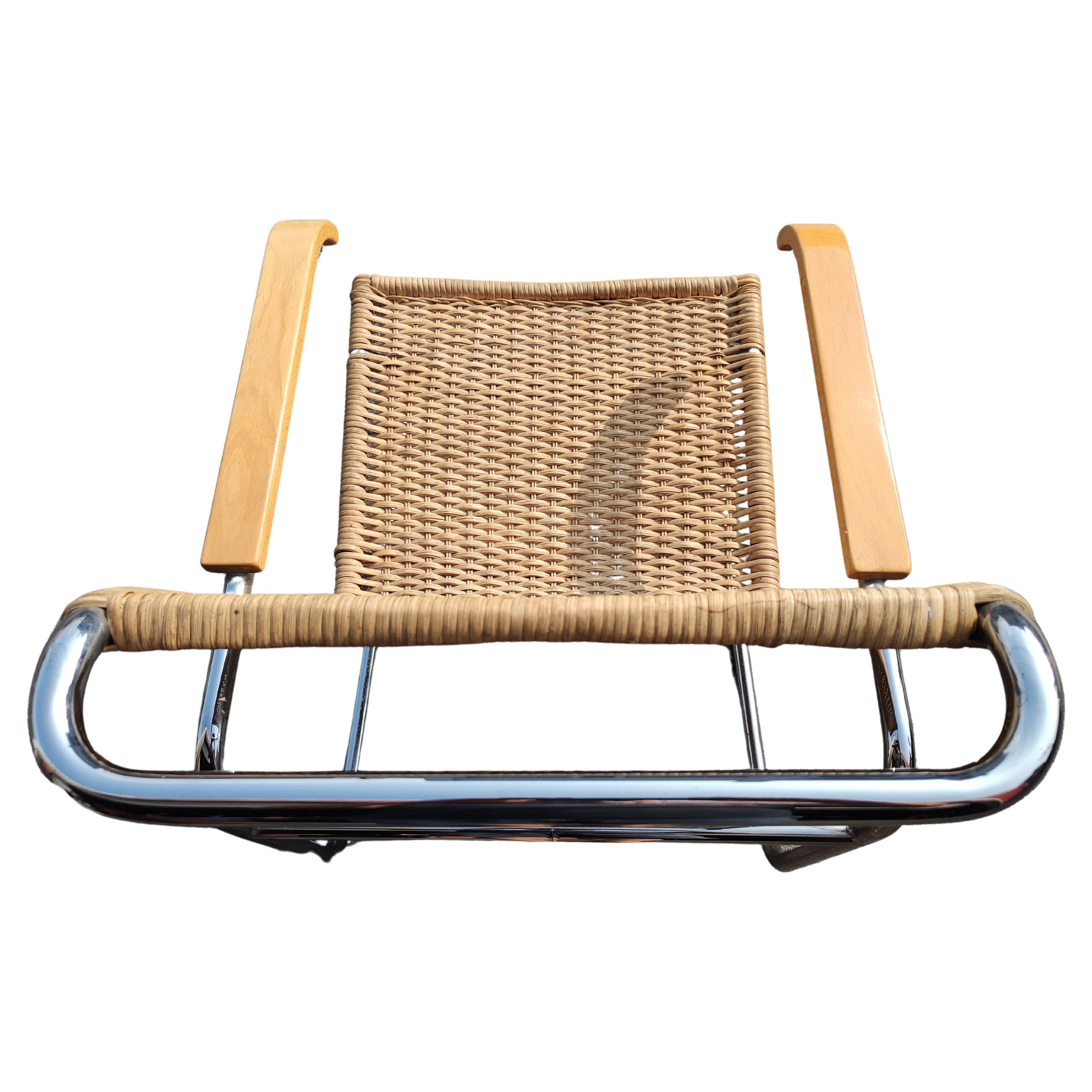 Fabulous and iconic design by Marcel Breuer from the Bauhaus period of the late twenties. Cantilevered chrome arms with maple armrests which wrap around the wicker body in a continuous motion. This particular B-35 model is from c1970 and made in