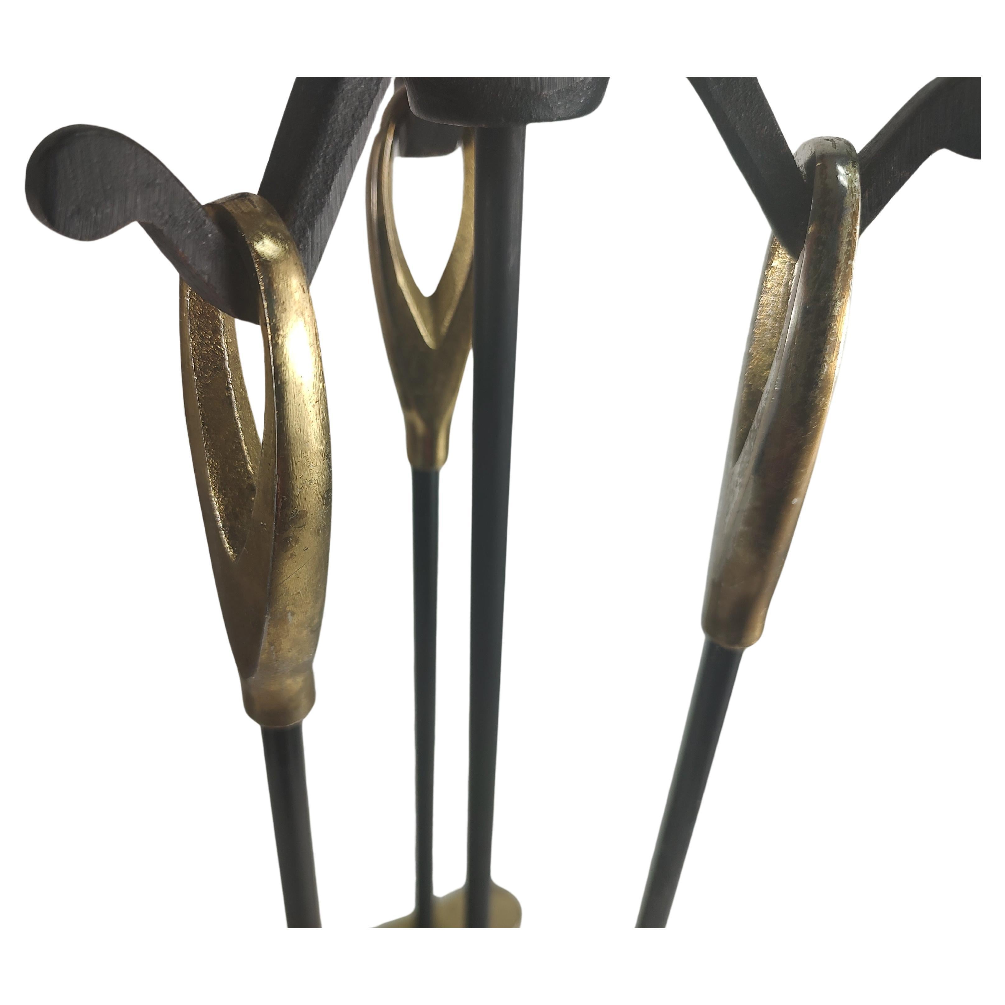 Fabulous 4 piece set of fireplace tools. Consists of brush poker shovel and the holder. Iron with brass accent handles in a teardrop form. Petite set for the smaller area, possibly a bedroom fireplace. In excellent vintage condition with minimal