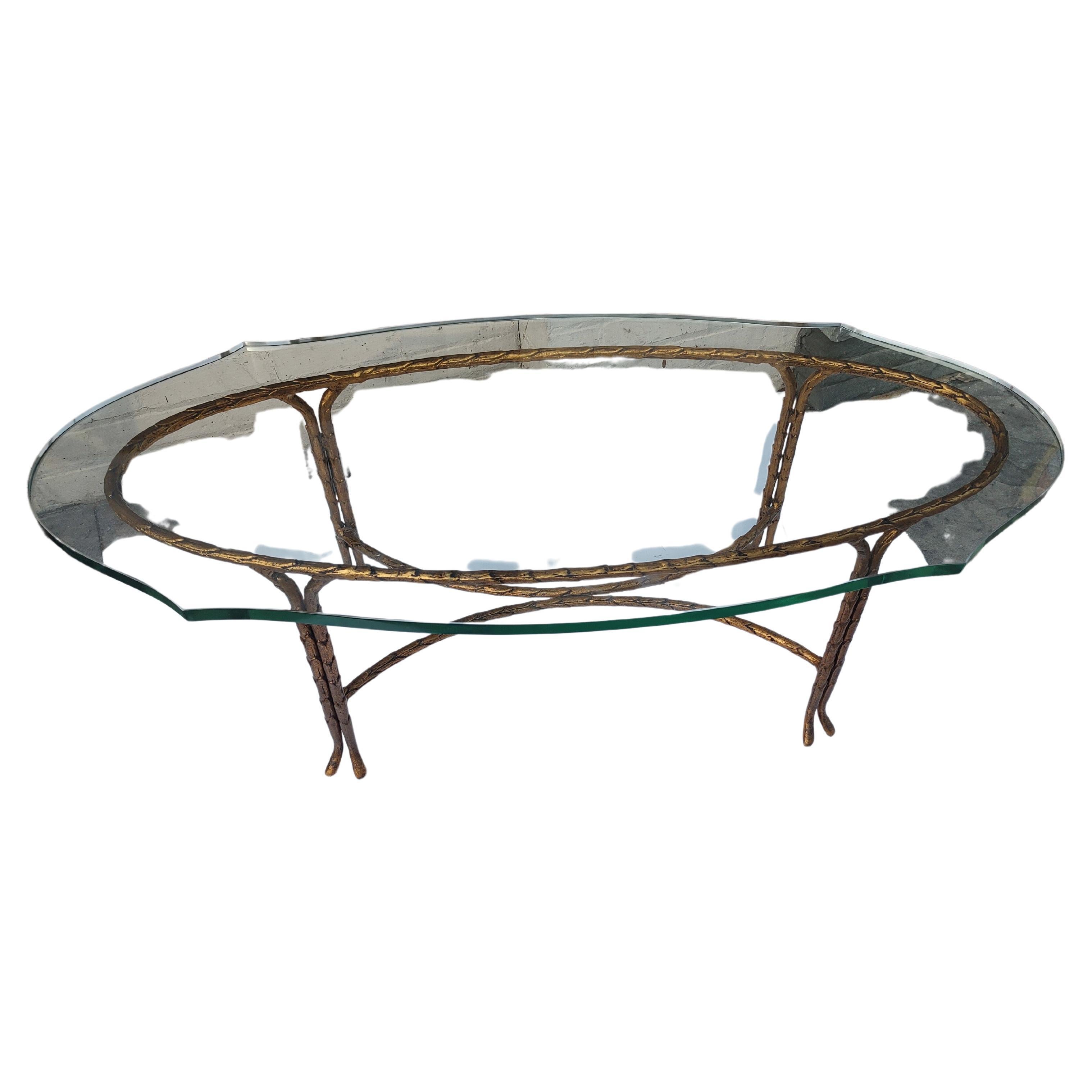 Fabulous simple and elegant organic style Gilt iron in the form of leaves on branches. Beautiful table attributed to Maison Bagues, high quality. Turtle top thick dimensional glass. Glass has some scratches but is chip free. 48 x 22 x 16h. Minor
