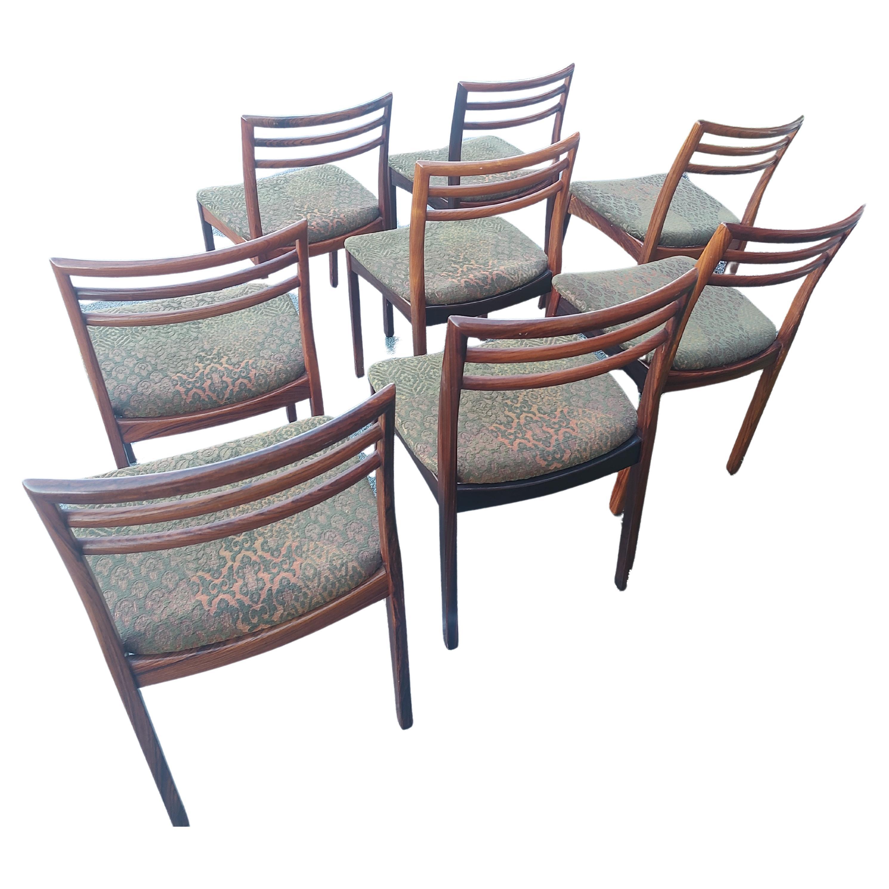 Fabulous set of 8 Rosewood Ladderback Dining chairs by Niels Otto Moeller. Spectacular graining in these Brazilian Rosewood chairs. Ladderback styling. Splines in joints on chair backs. Chairs have been well taken care of as they are in excellent