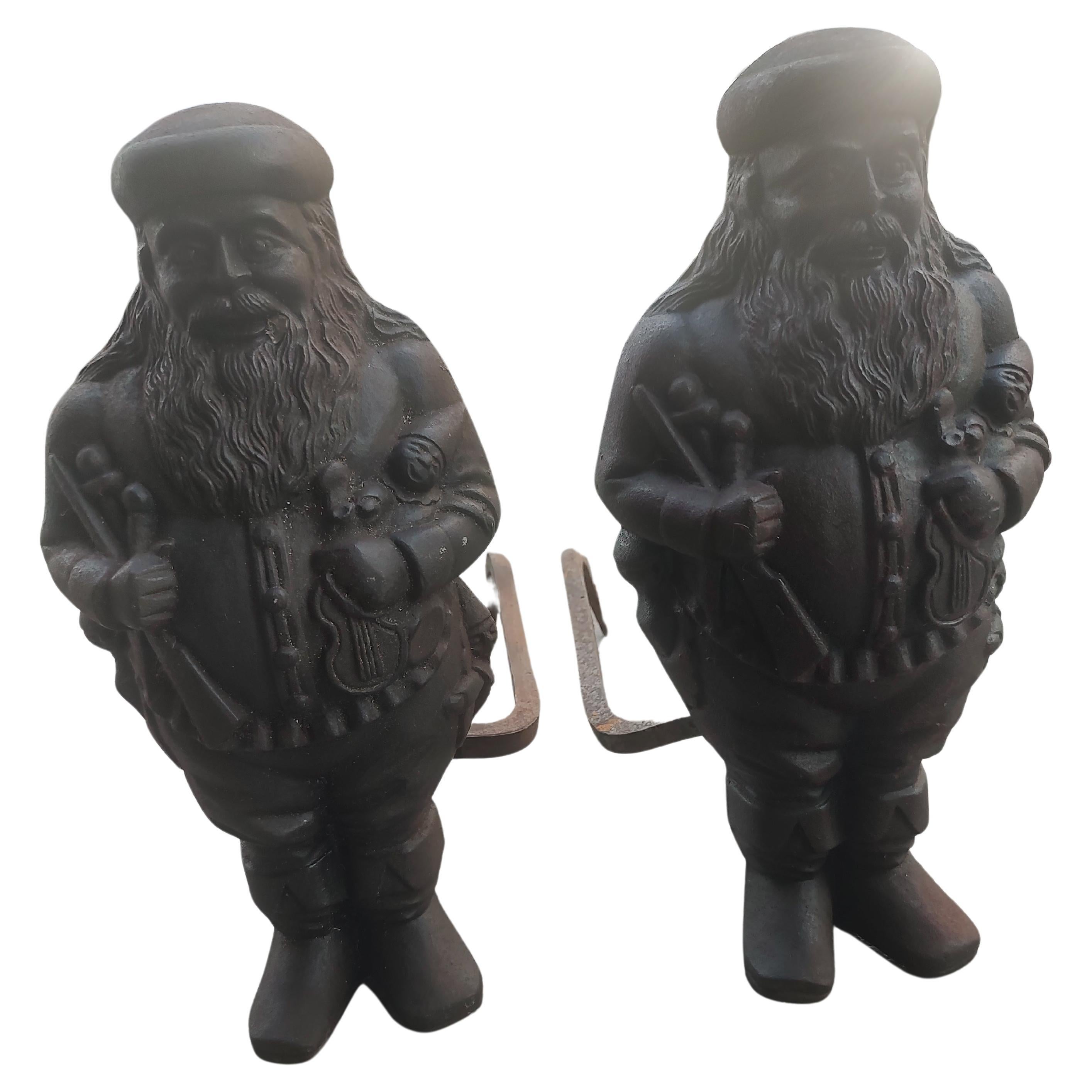 Fabulous pair of cast iron Santa Claus andirons by Virginia Metalcrafters c1950. Excellent castings, very detailed with Santa having toys and presents on his body. In very good condition with just normal wear & tear patina. 