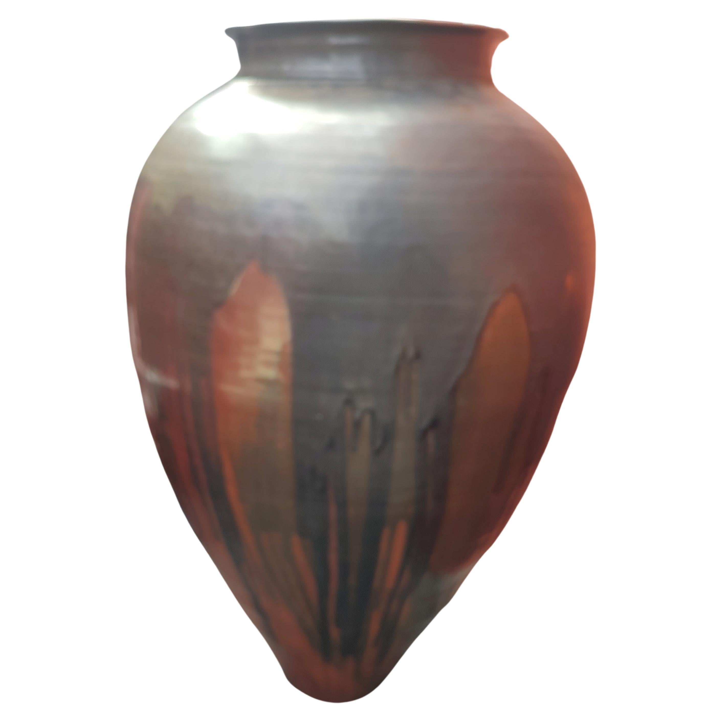 Fabulous and massive vase - urn which will be a eye catcher in your living or business space. Almost 4 ft tall and 30 inch at its widest in the center down to about 7 inch at the base. Fantastic orange and brown drip glaze with some other colors