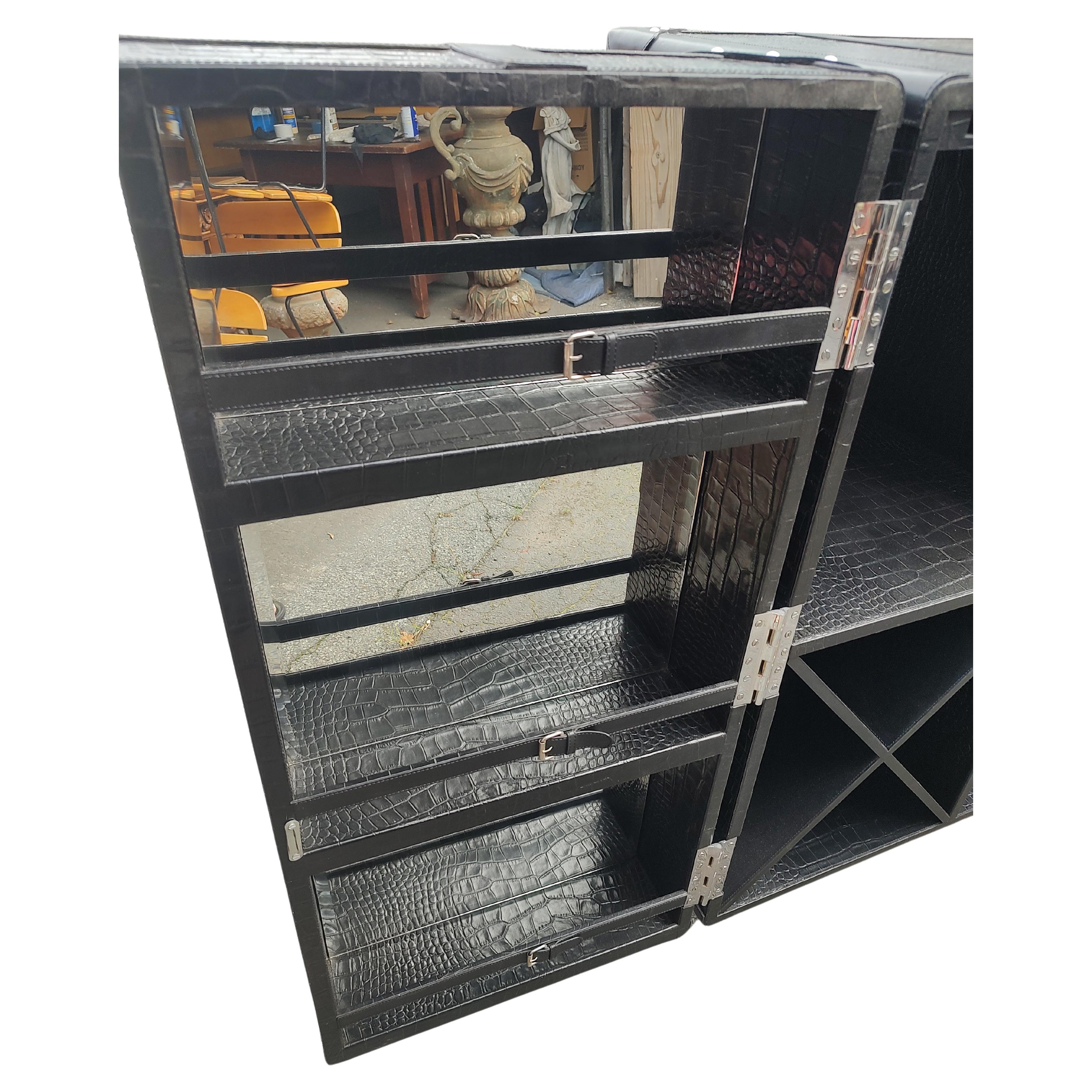 Fabulous bar Cabinet on wheels. Embossed crocodile leather cabinet with a totally fitted and mirrored areas for storage and celebration. Cabinet opens up French door style with shelving and compartments on the inside of the doors as well. All fitted
