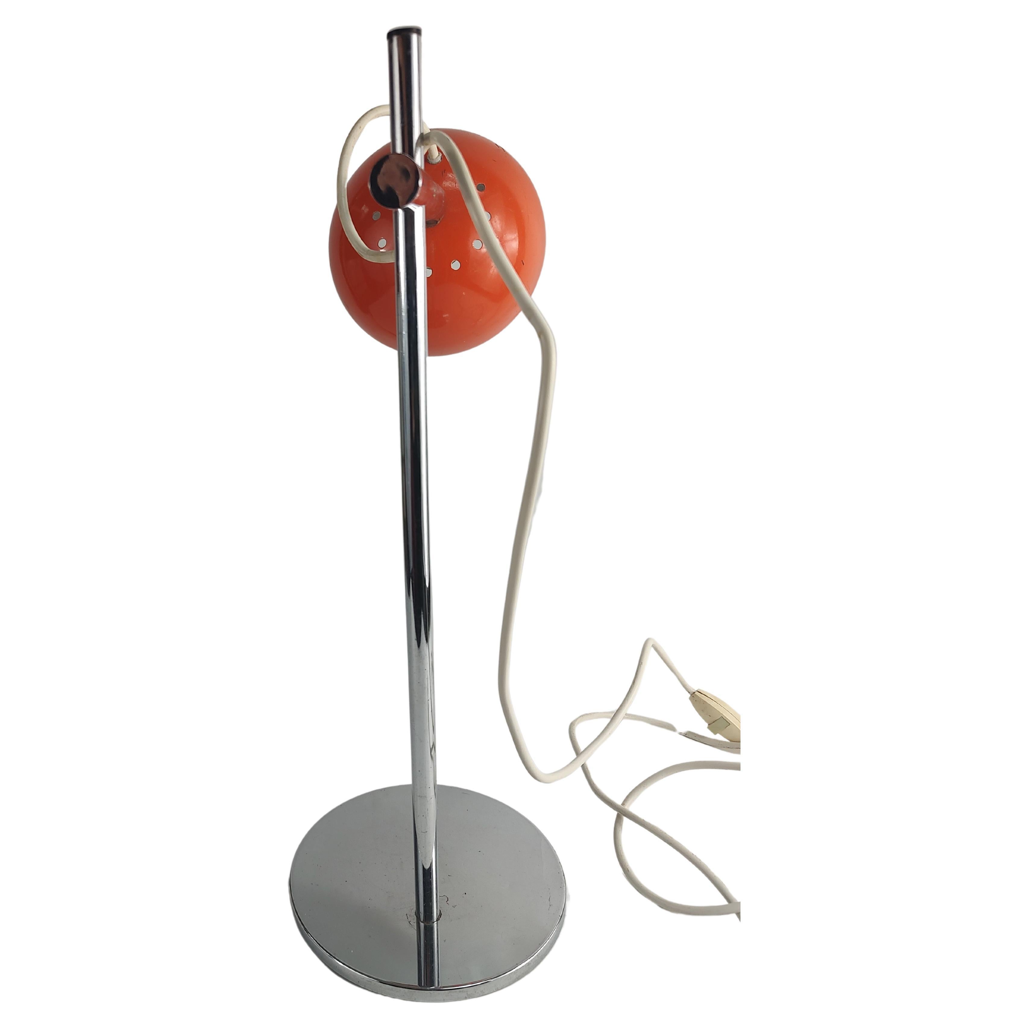 Fabulous eye ball style lamp in orange with a chrome base and shaft. Eye ball shade is fully adjustable. Chrome is in excellent vintage condition shade has some wear see pics.