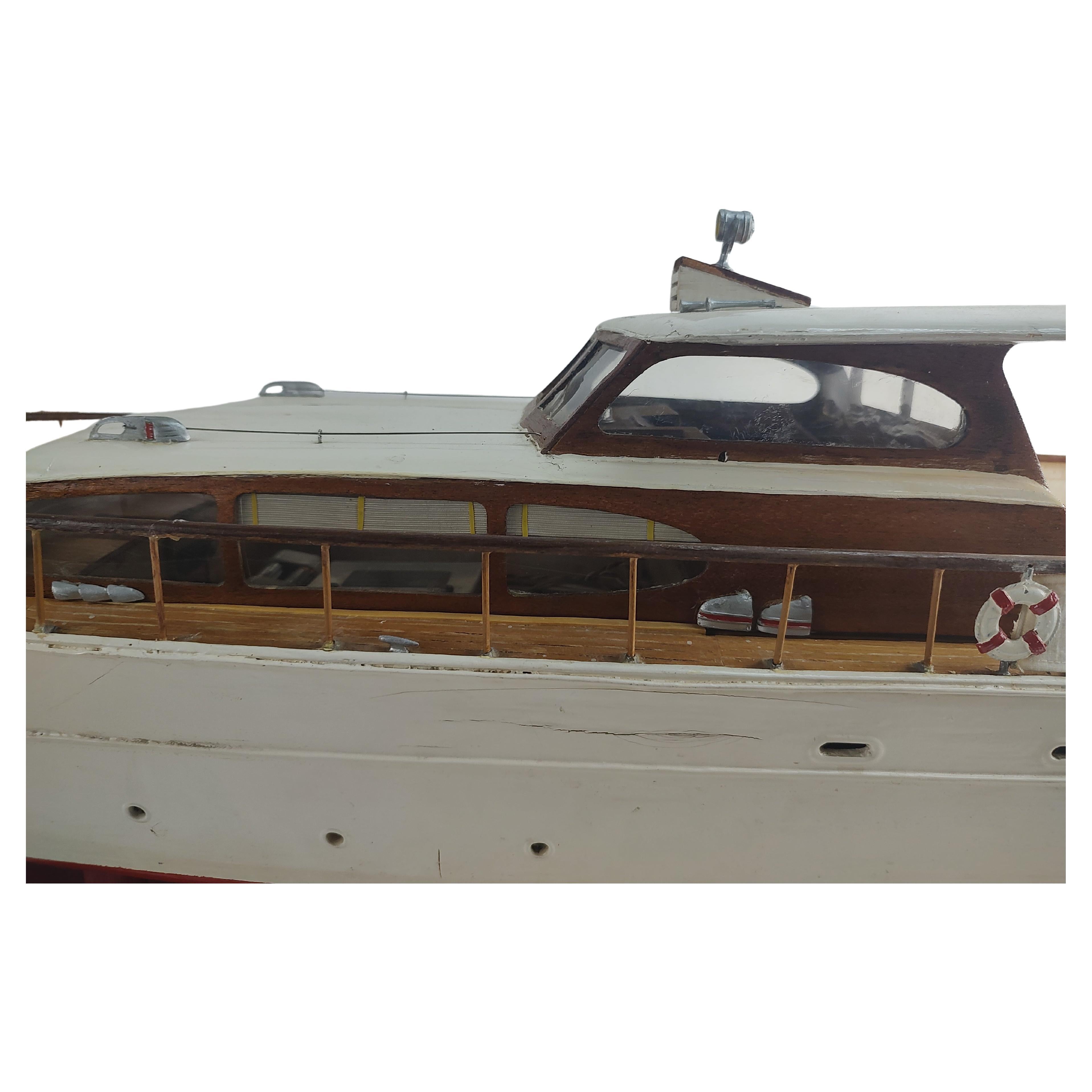 Fabulous and large cabin cruiser boat model with an untested motor and batteries. 41.5 inches long and sitting on a brand new custom made stand with a nautical theme. In very good vintage condition with some minor age related wear. Has it all going