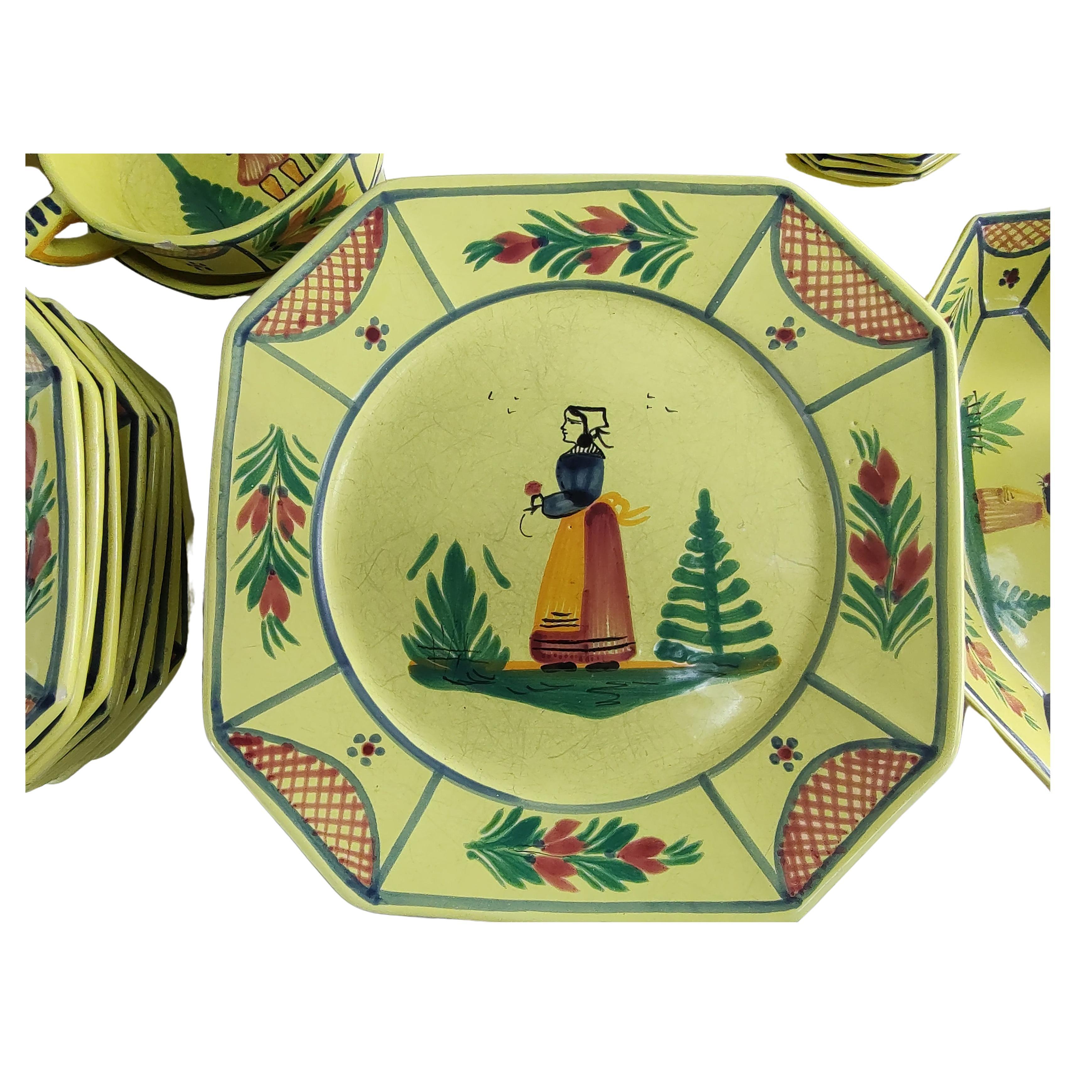 Fabulous dinner set of 50 pieces by the Henriot Quimper co. Their beautiful yellow color with the traditional peasant man ,& woman. Handmade & hand painted set is a classic. Set consists of 7 10