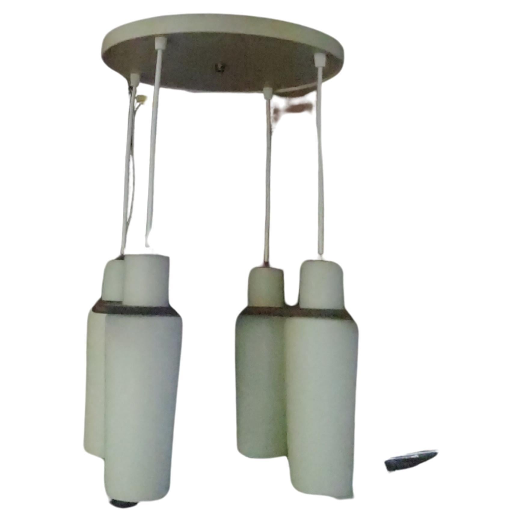 Simple and elegant 4 light pendant chandelier from Denmark. Blown in a mold milk Glass shades with walnut caps & hanger. All the wood is stamped Denmark. Totally rewired. In excellent vintage condition with minimal wear. Original metal canopy,