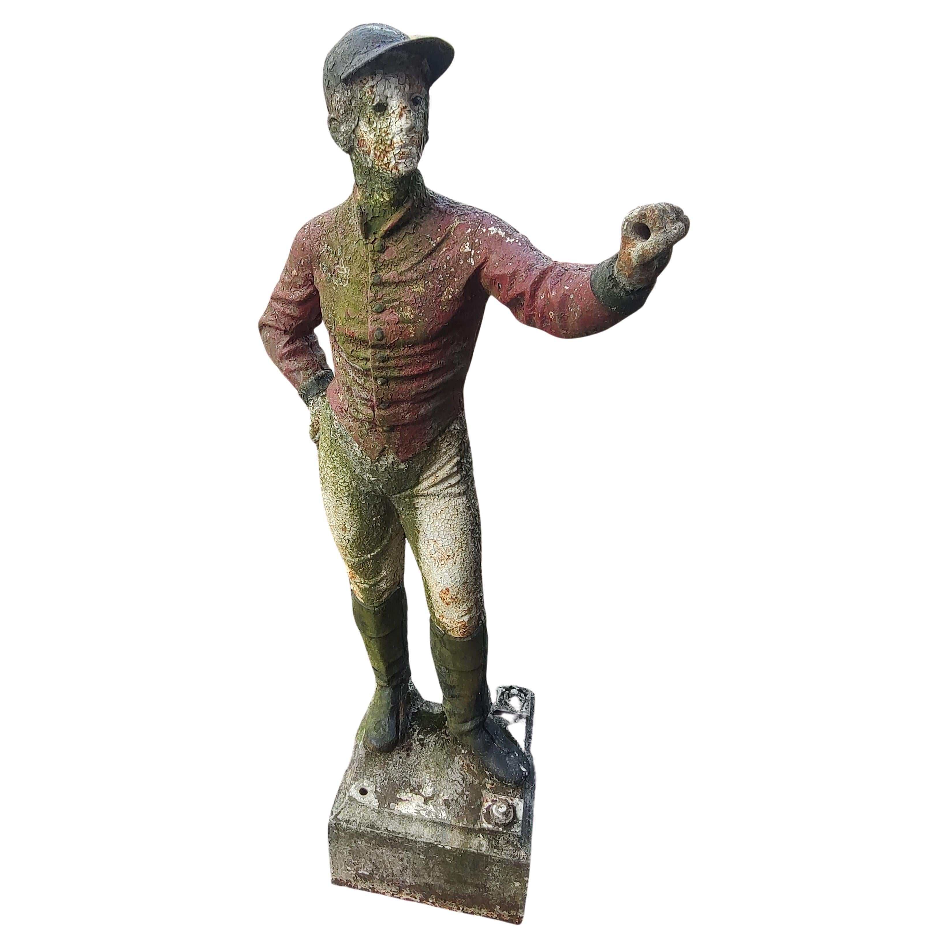 Spectacular and most likely a 19th century representation of a lawn jockey in cast iron. In excellent antique condition with minimal wear, some separation at the seams where they join, only on the feet, minor.  In old paint with moss. Almost 52