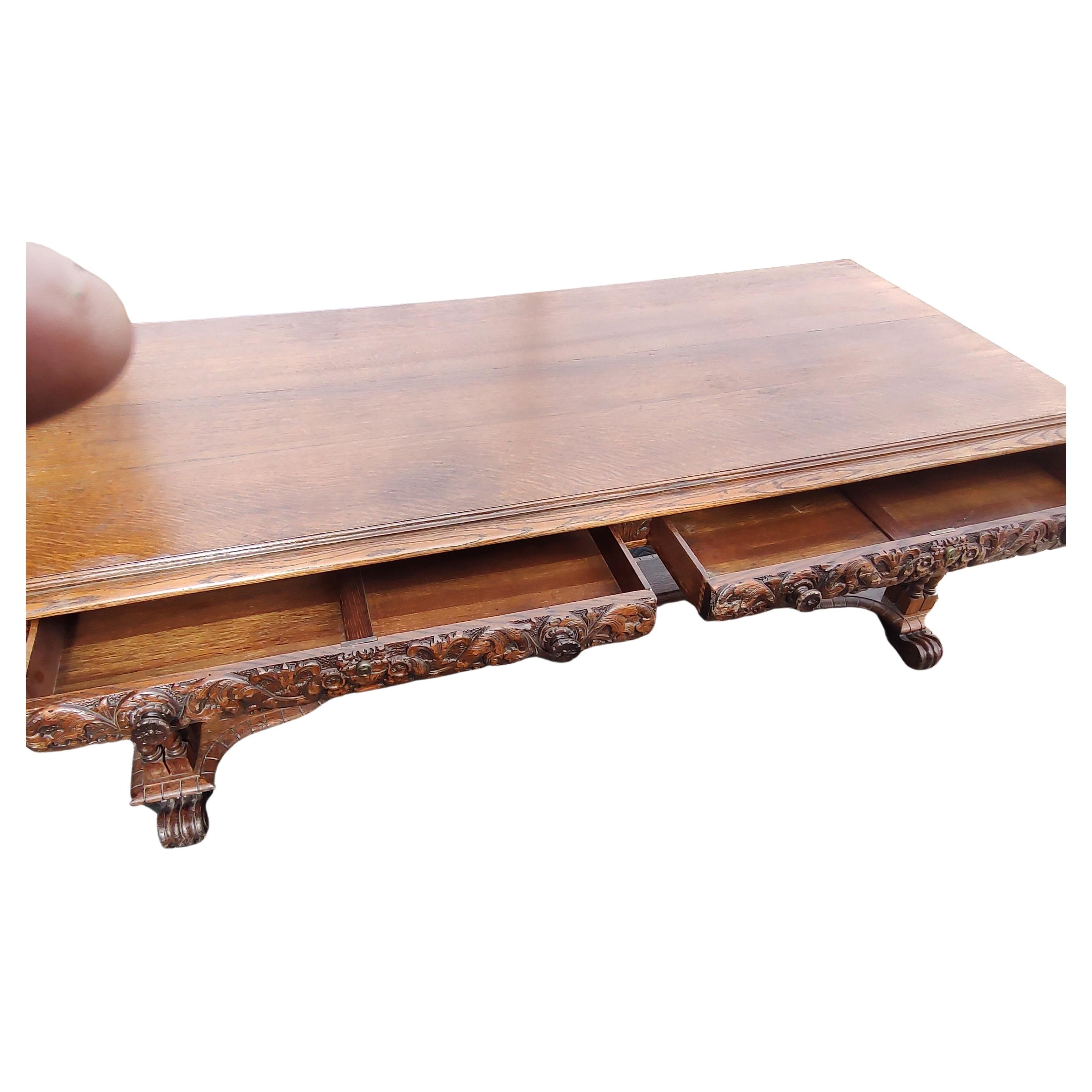 Fabulous and beautifully carved large oak library table or partners desk with two drawers on each side. Quarter sawn oak with amazing grain, beautiful boards top with a carved edge. Four barley turned legs on each corner and three spaced in the