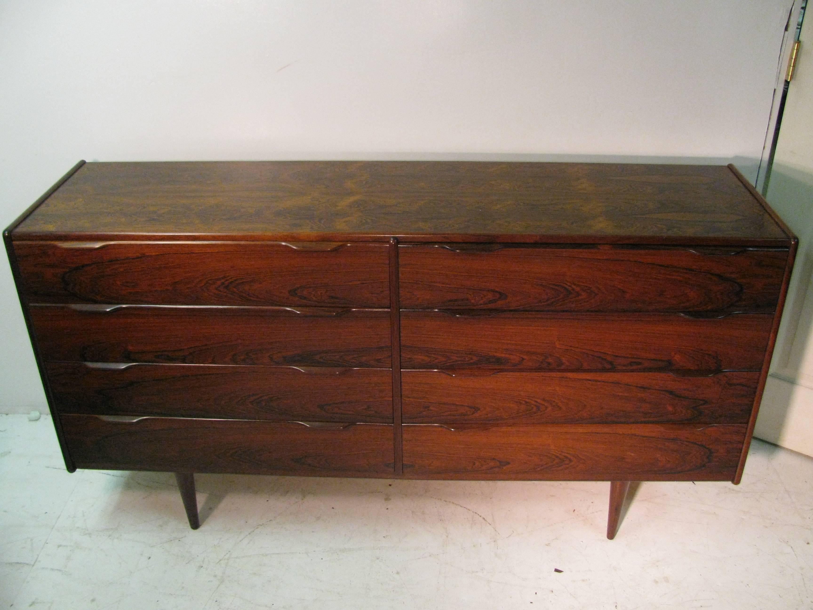 Simple and elegant rosewood long eight-drawer dresser. Bookmatched rosewood with solid rosewood pulls. Plenty of storage. Excellent condition with minor wear.