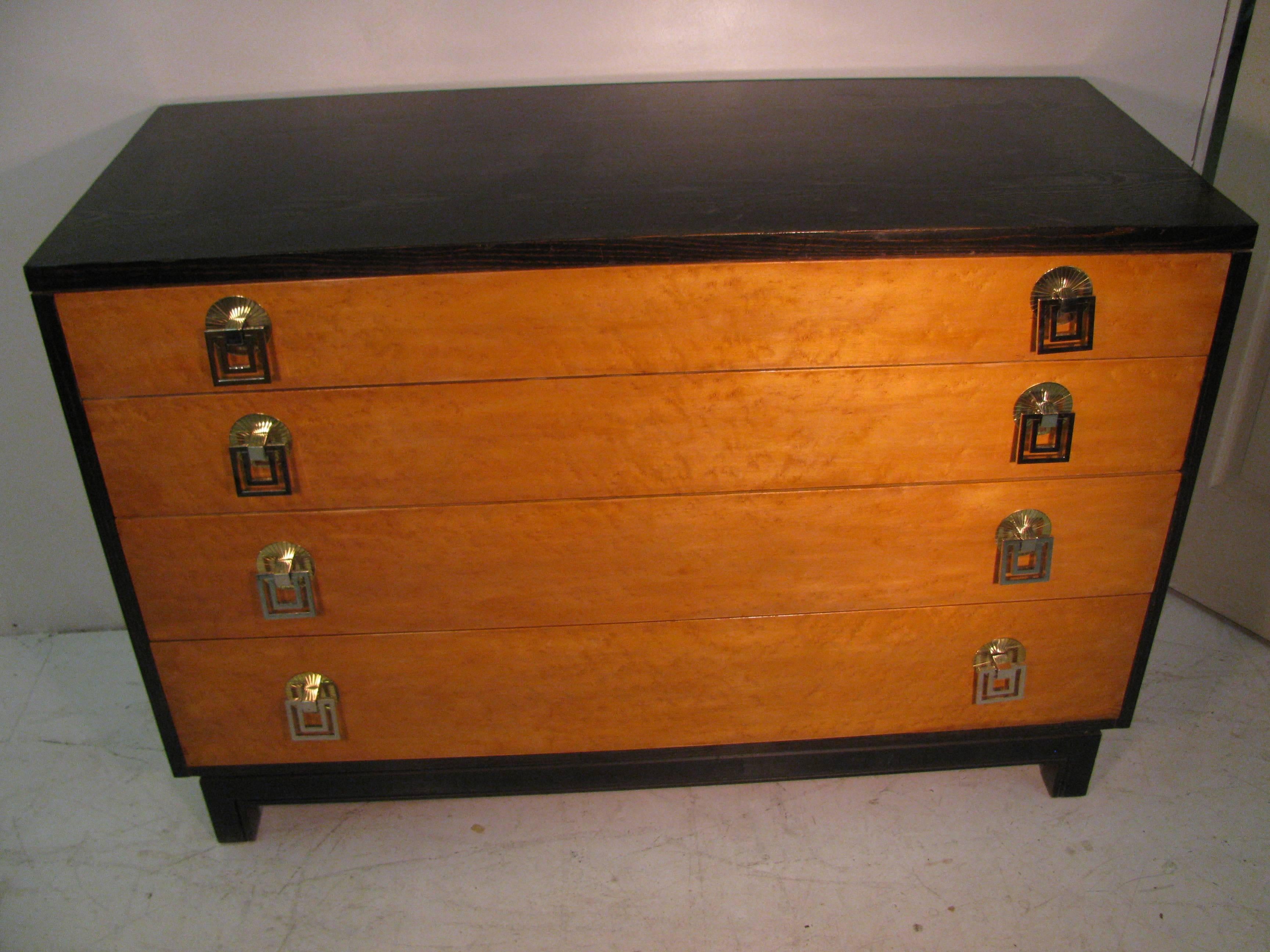 Pair of beautiful chests by Renzo Rutili. Simple and elegant design with bird's-eye maple fronts surrounded by ebony oak. Solid brass pulls in a Asian style. Case appears to be floating on base. A few blemishes on top. Great size with plenty of